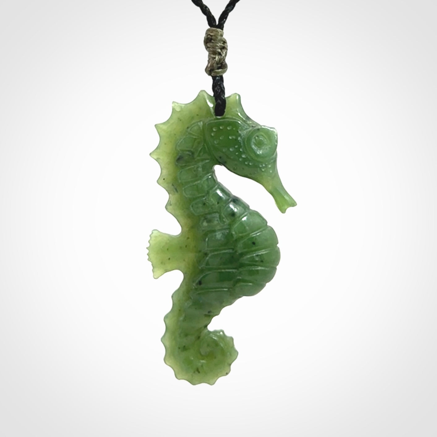A hand carved seahorse pendant. We have carved this from beautiful nephrite jade and we bind them with our hand-plaited cords. We ship these worldwide with express courier anywhere in the world.