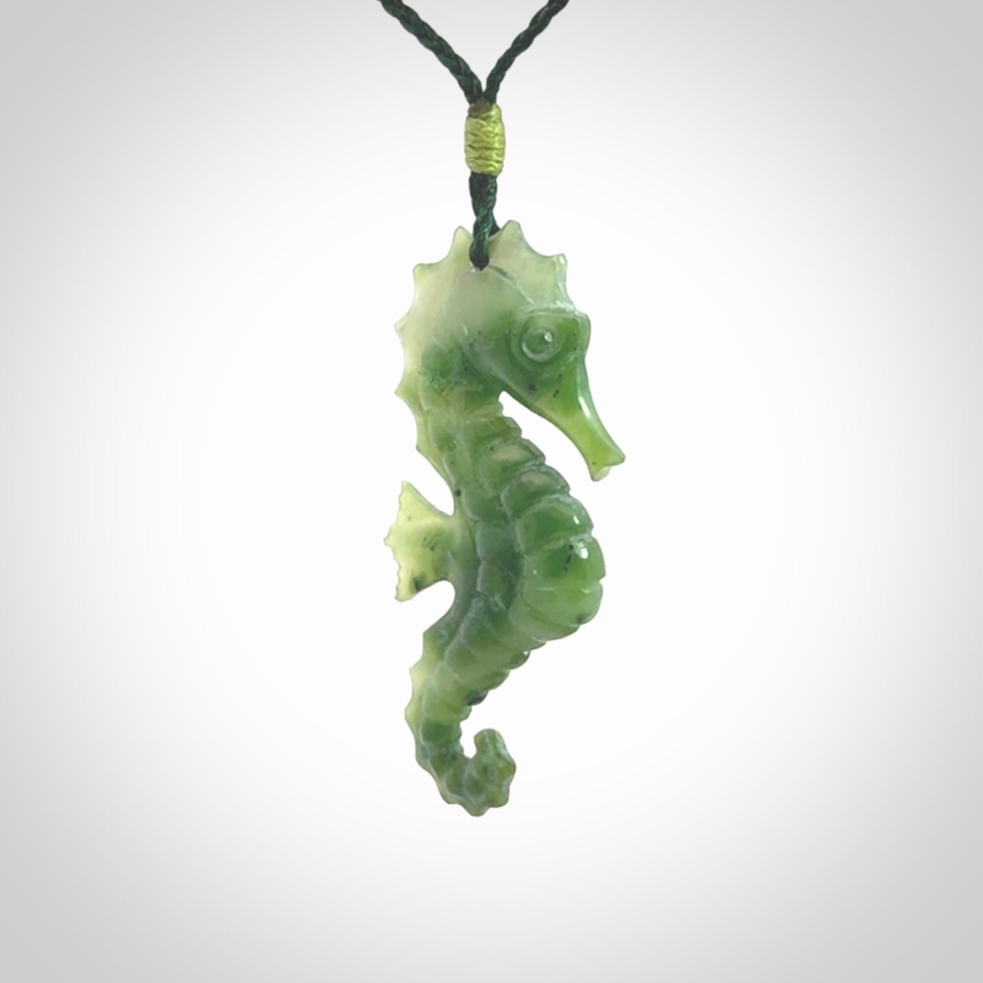 A hand carved seahorse pendant. We have carved this from beautiful nephrite jade and we bind them with our hand-plaited cords. We ship these worldwide with express courier anywhere in the world.