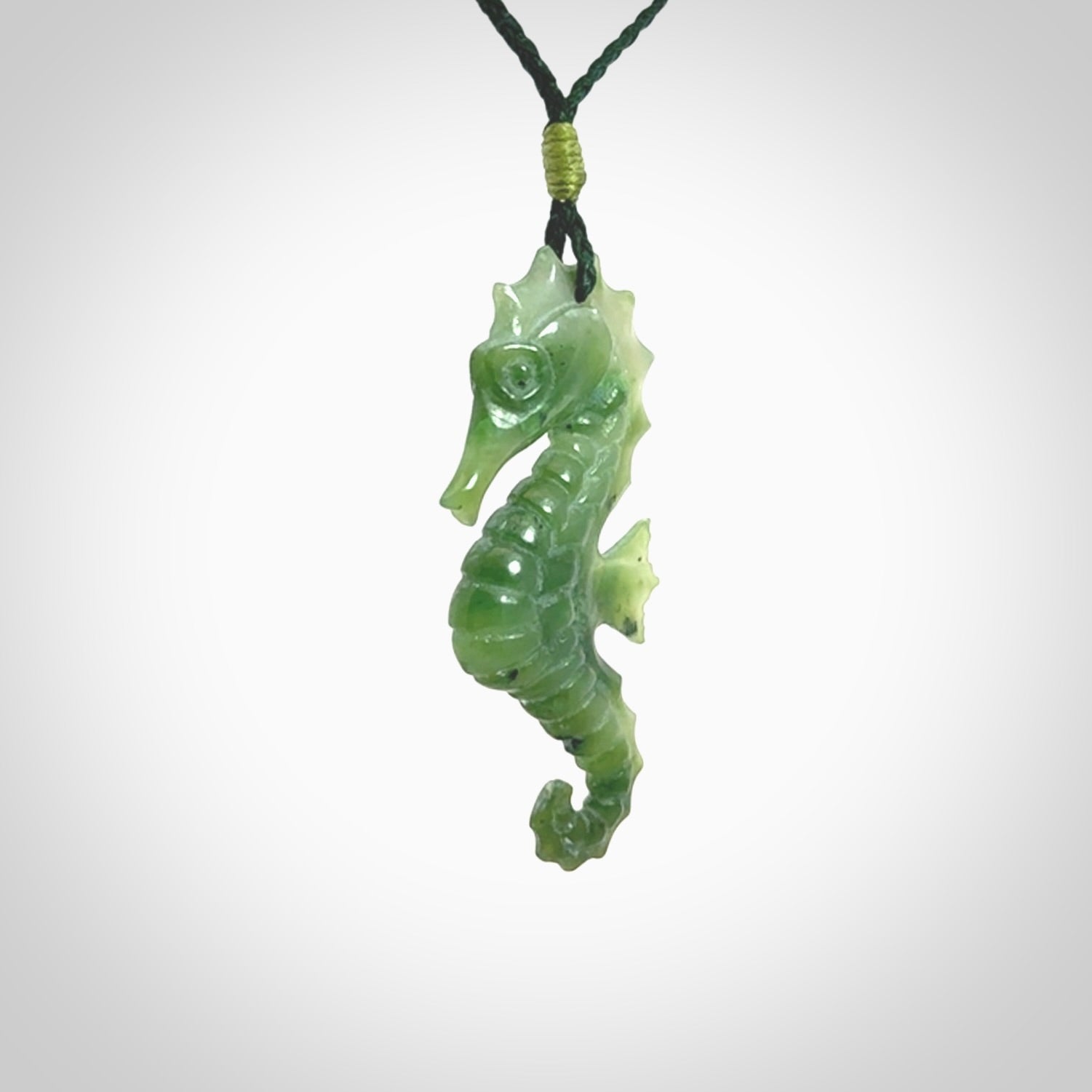 A hand carved seahorse pendant. We have carved this from beautiful nephrite jade and we bind them with our hand-plaited cords. We ship these worldwide with express courier anywhere in the world.
