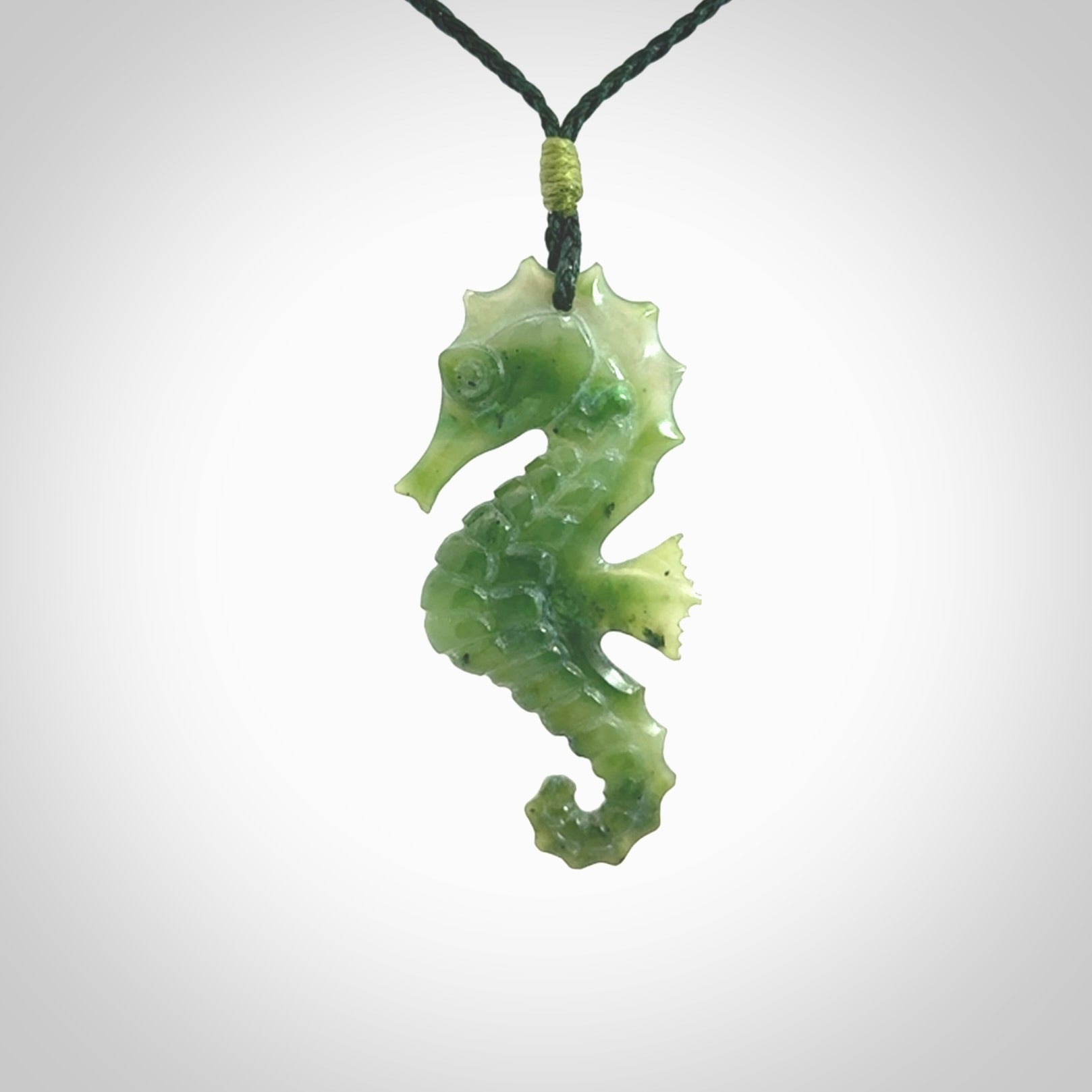 A hand carved seahorse pendant. We have carved this from beautiful nephrite jade and we bind them with our hand-plaited cords. We ship these worldwide with express courier anywhere in the world.