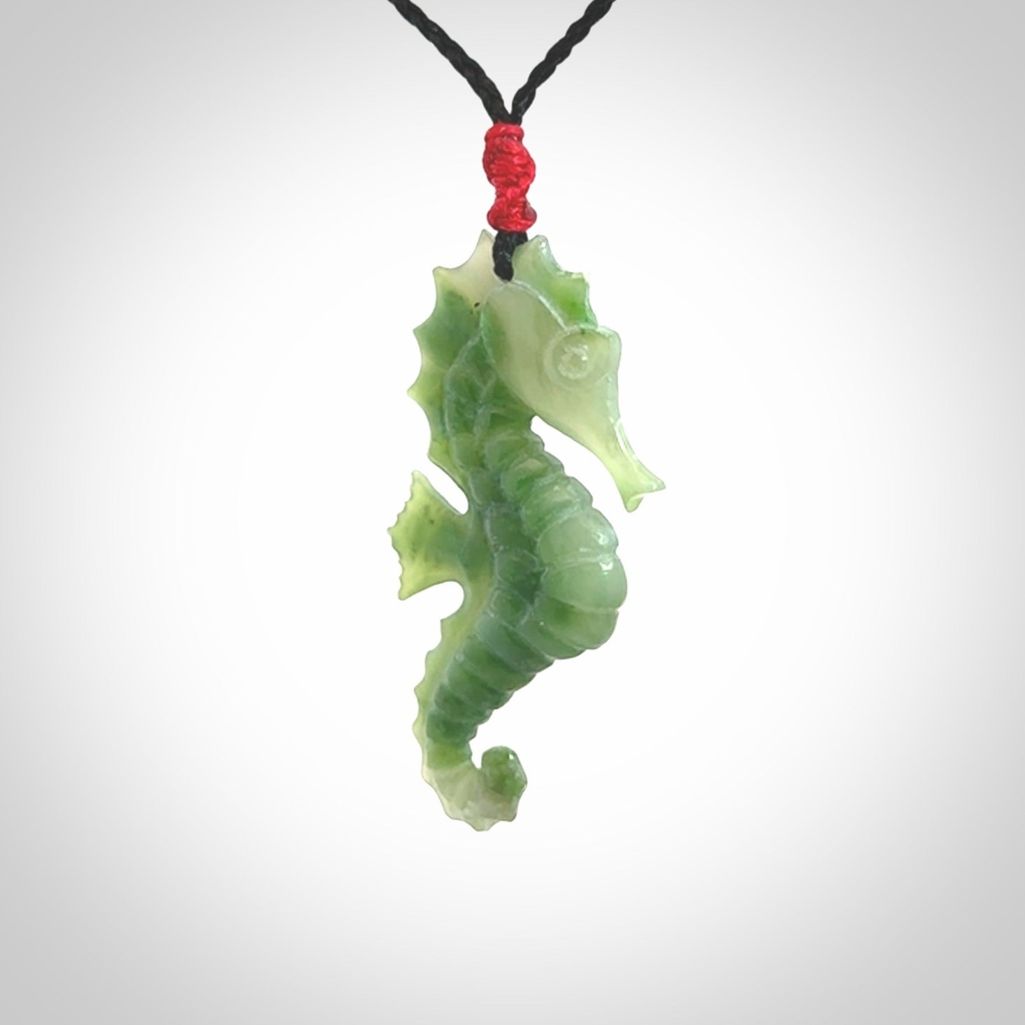 A hand carved seahorse pendant. We have carved this from beautiful nephrite jade and we bind them with our hand-plaited cords. We ship these worldwide with express courier anywhere in the world.