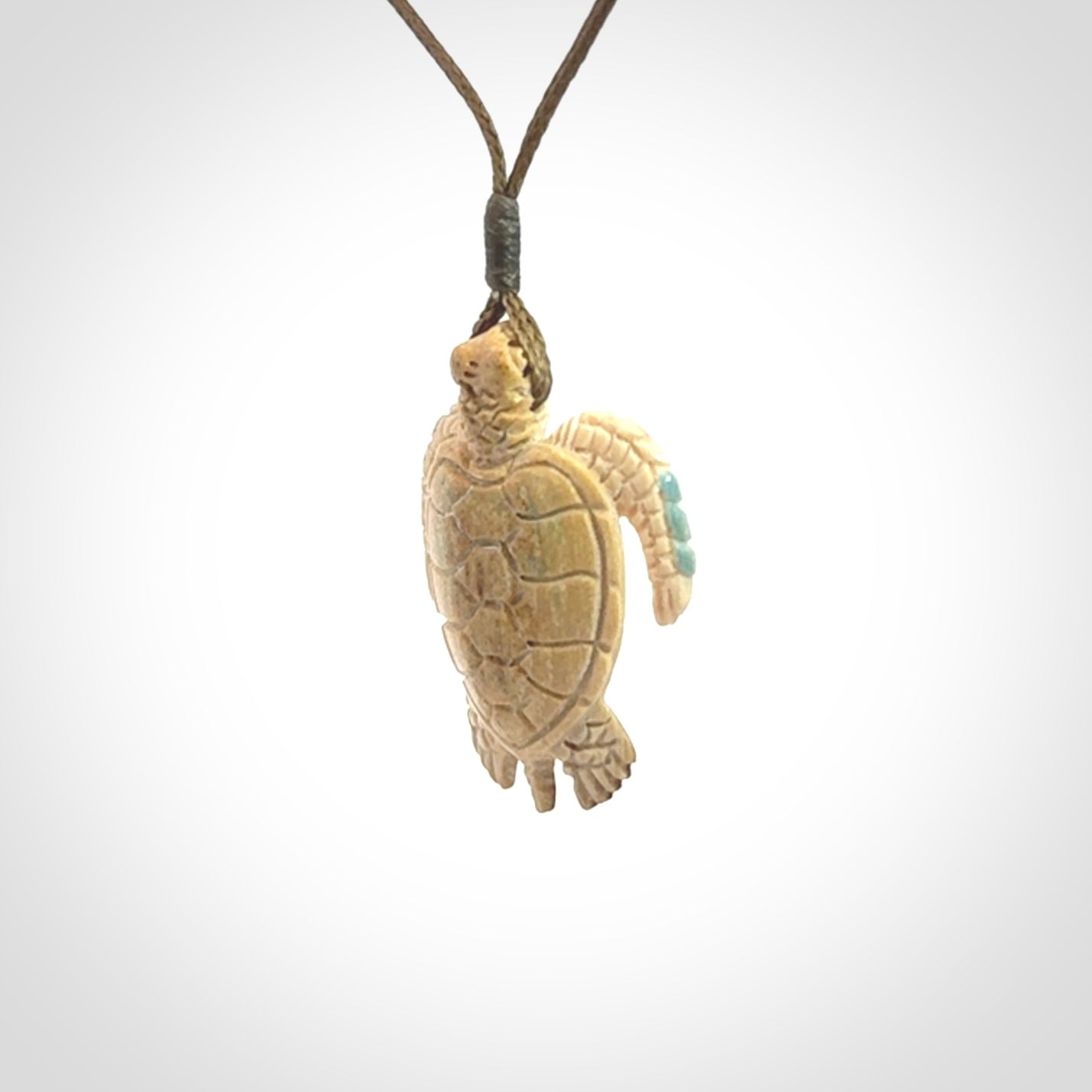 This is a beautiful hand carved woolly mammoth tusk turtle pendant. A really cool piece that is made from this rare and beautiful material. The mammoth has a very distinctive grain and each piece is different. We ship this worldwide and the cost of shipping is included in the price.