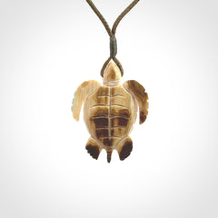 This is a beautiful hand carved woolly mammoth tusk turtle pendant. A really cool piece that is made from this rare and beautiful material. The mammoth has a very distinctive grain and each piece is different. We ship this worldwide and the cost of shipping is included in the price.