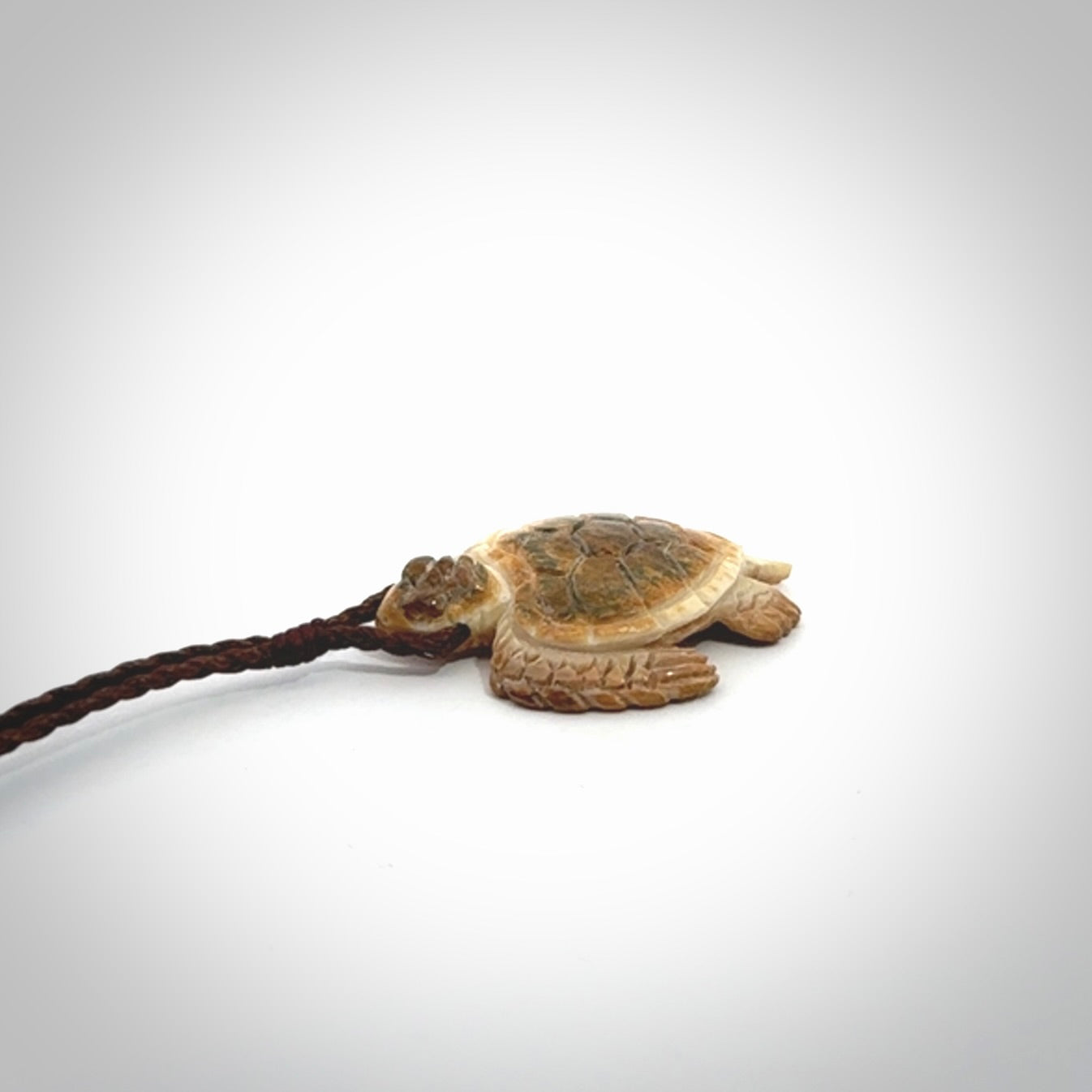 This is a beautiful hand carved woolly mammoth tusk turtle pendant. A really cool piece that is made from this rare and beautiful material. The mammoth has a very distinctive grain and each piece is different. We ship this worldwide and the cost of shipping is included in the price.