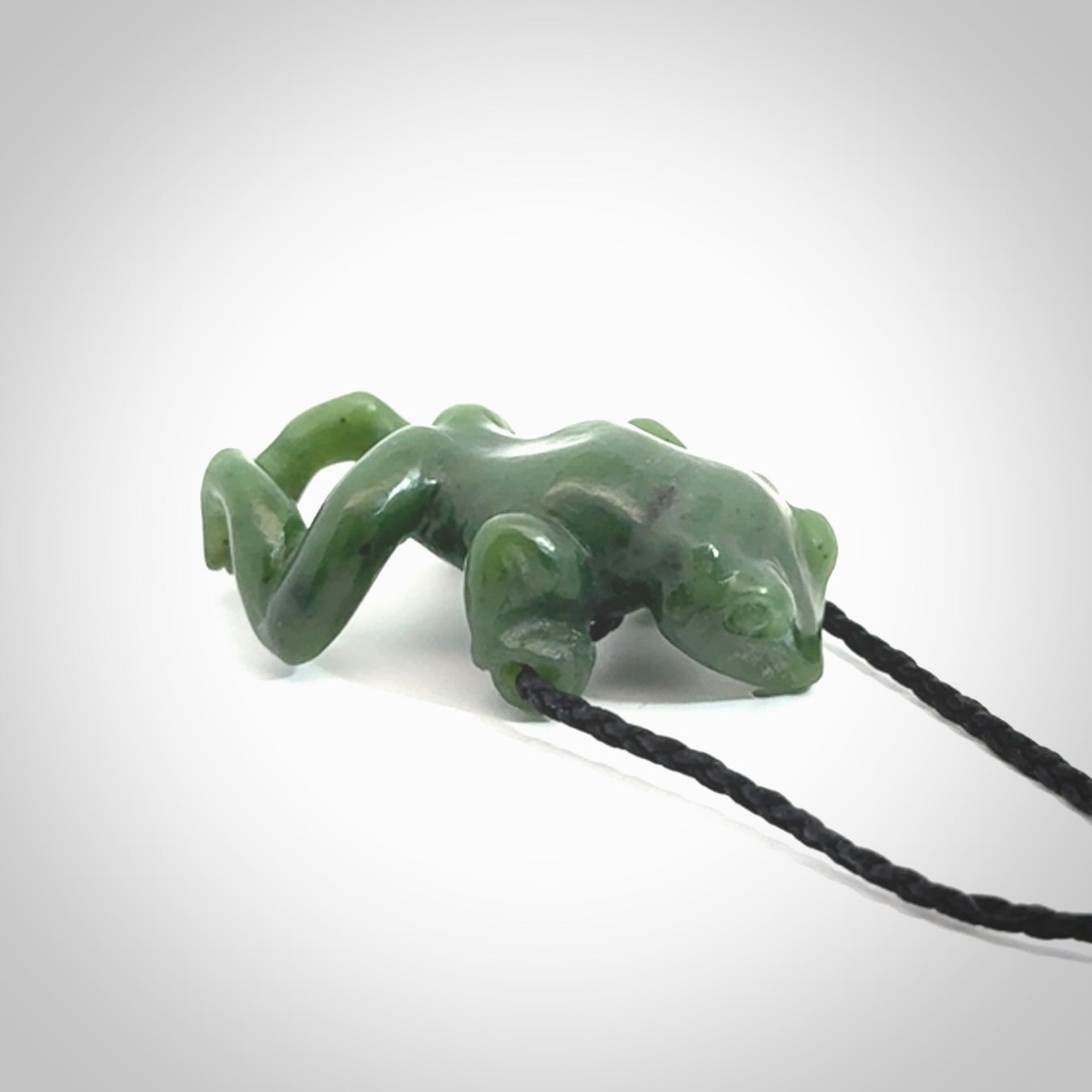 Hand carved jade frog pendant with adjustable cord.
