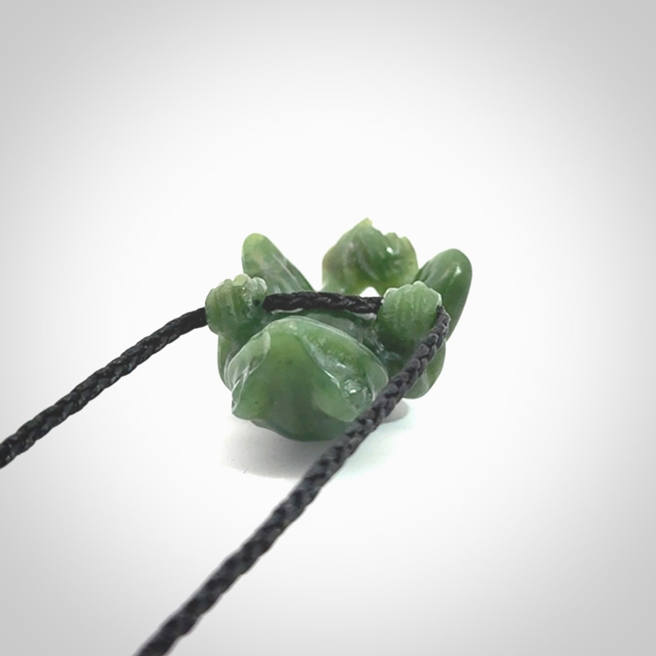 Hand carved jade frog pendant with adjustable cord.