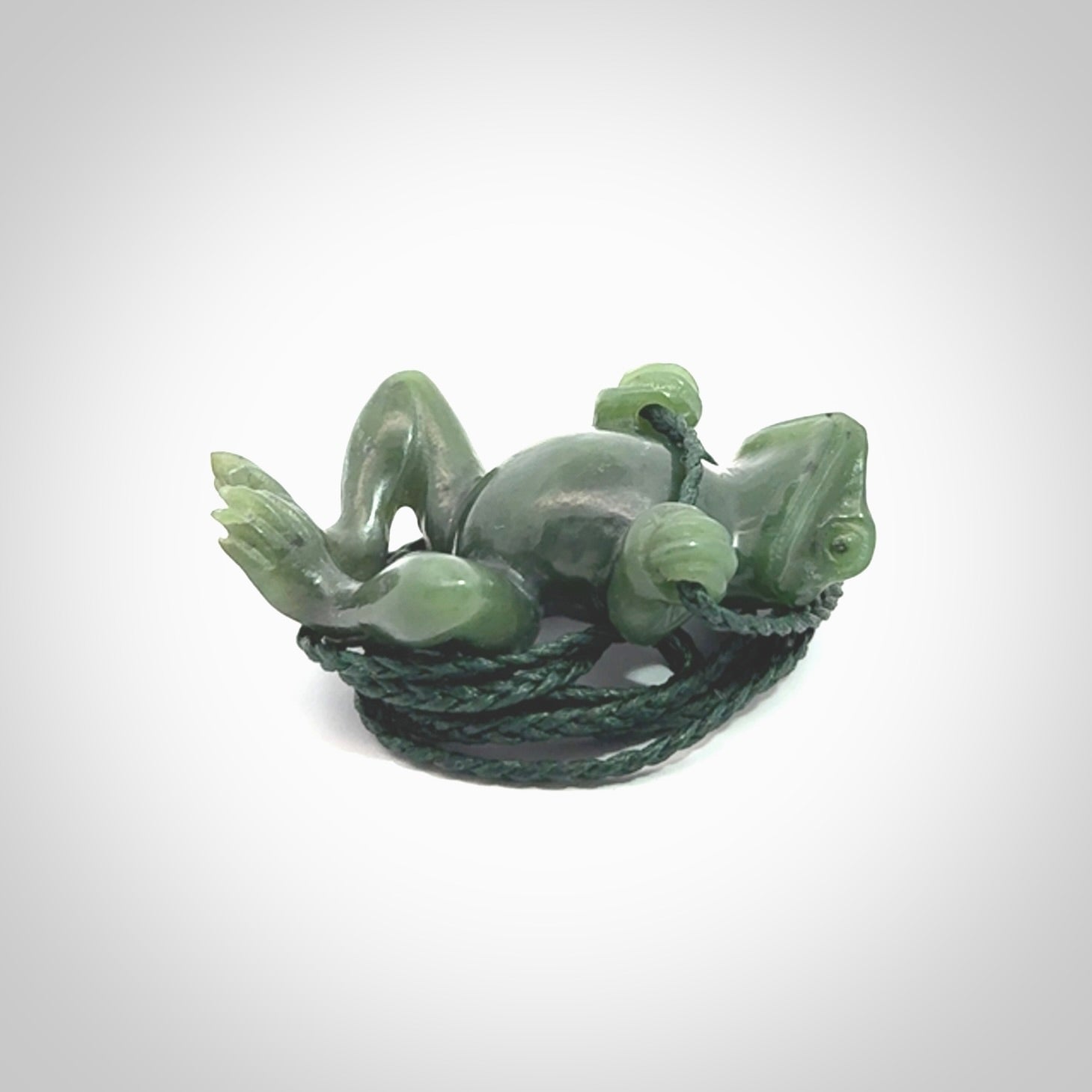 Hand carved jade frog pendant with adjustable cord.