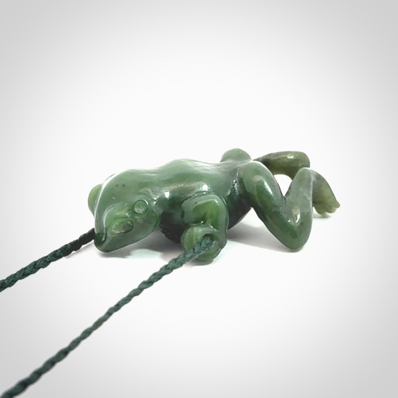 Hand carved jade frog pendant with adjustable cord.