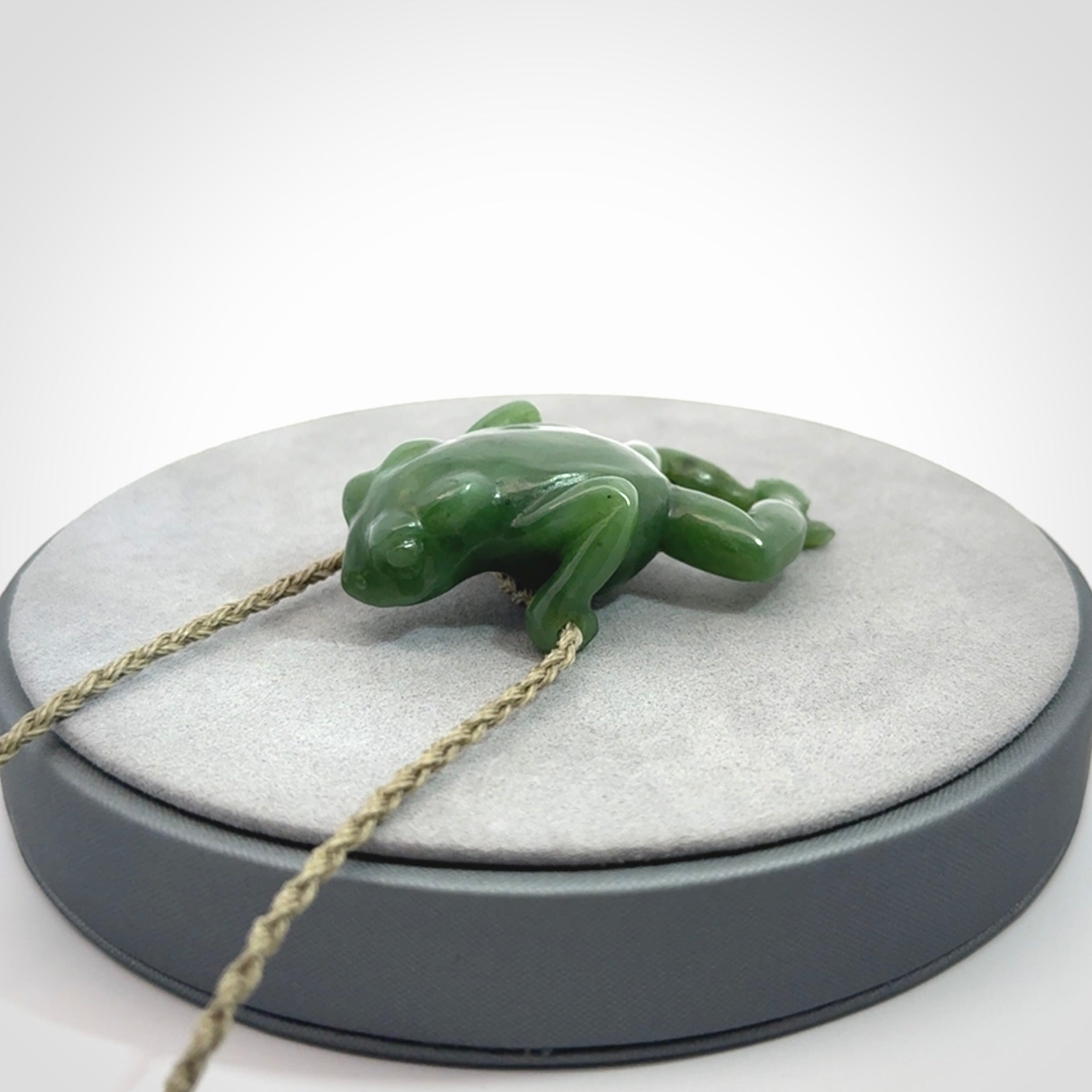 Hand carved jade frog pendant with adjustable cord.
