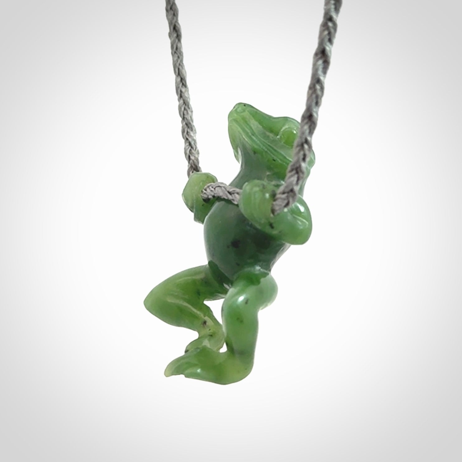 Hand carved jade frog pendant with adjustable cord.