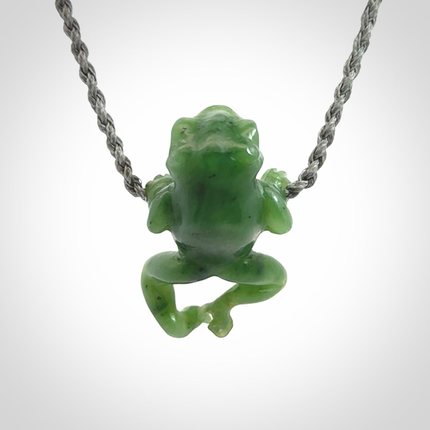 Hand carved jade frog pendant with adjustable cord.
