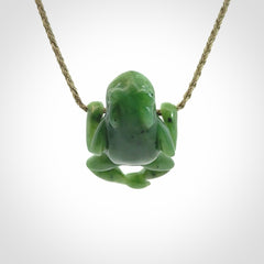 Hand carved jade frog pendant with adjustable cord.