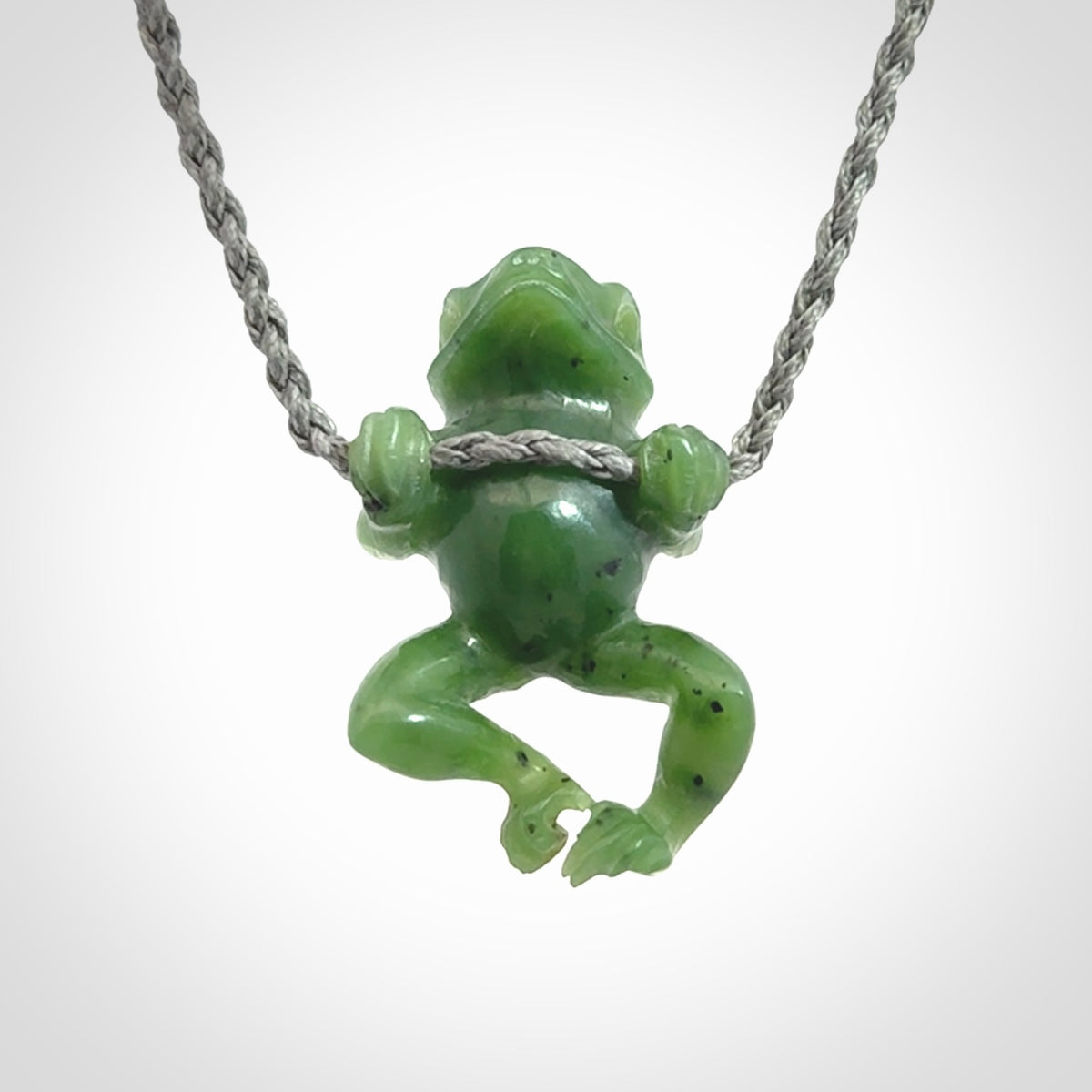 Hand carved jade frog pendant with adjustable cord.