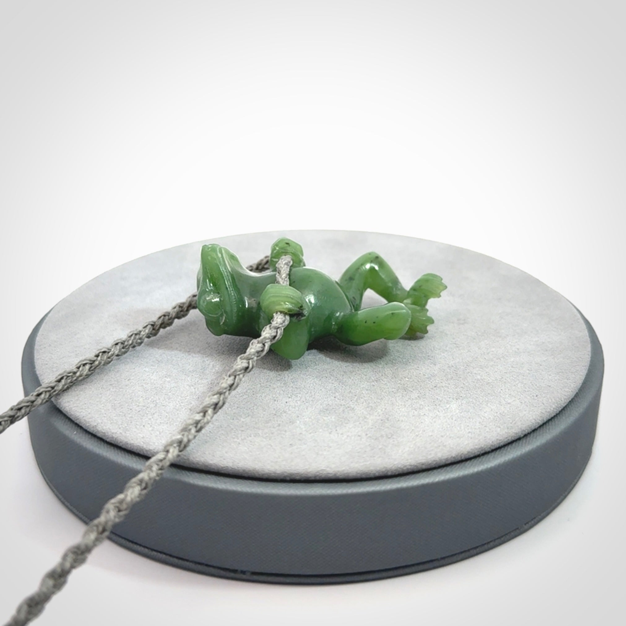 Hand carved jade frog pendant with adjustable cord.