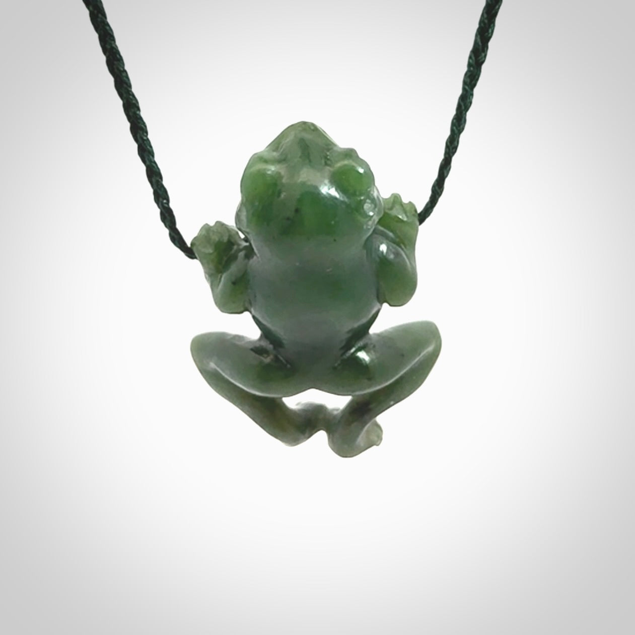 Hand carved jade frog pendant with adjustable cord.