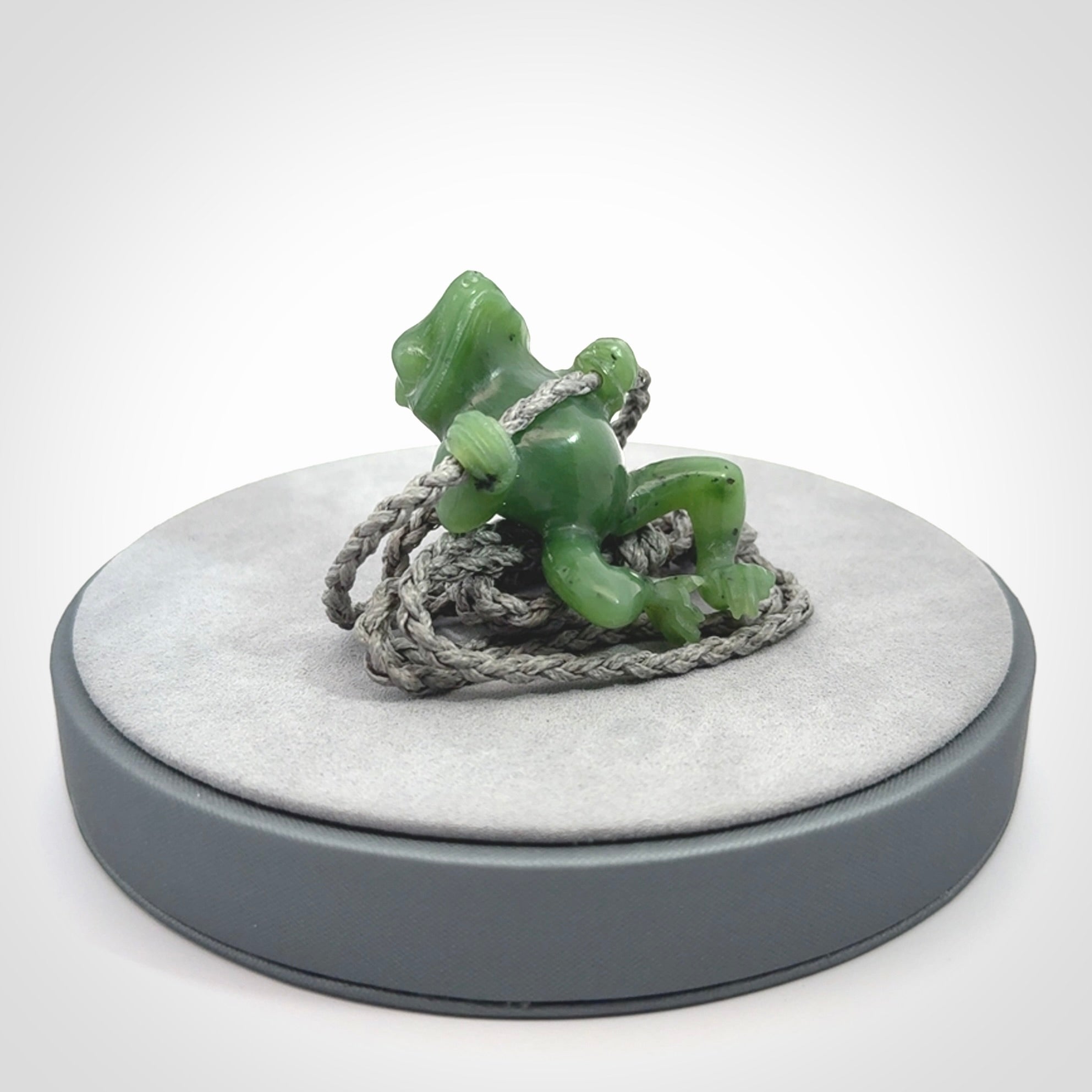 Hand carved jade frog pendant with adjustable cord.