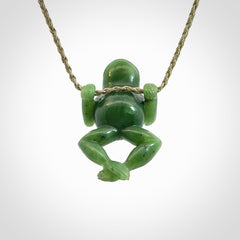 Hand carved jade frog pendant with adjustable cord.