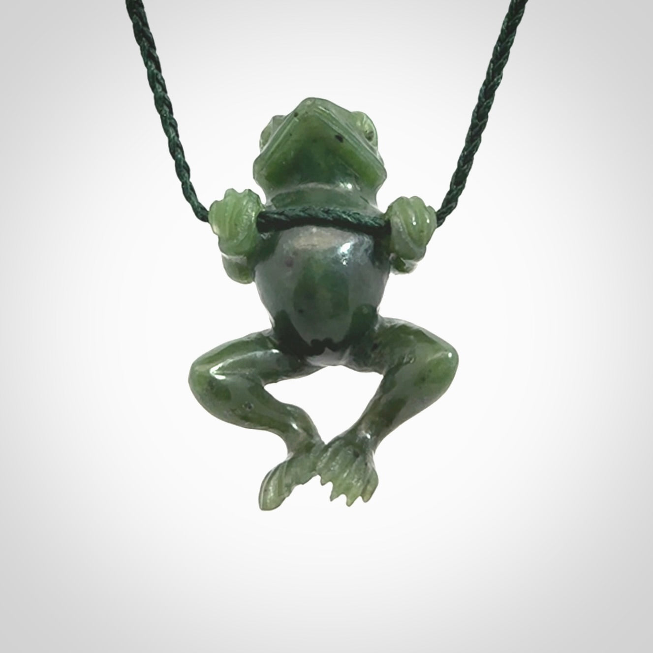 Hand carved jade frog pendant with adjustable cord.