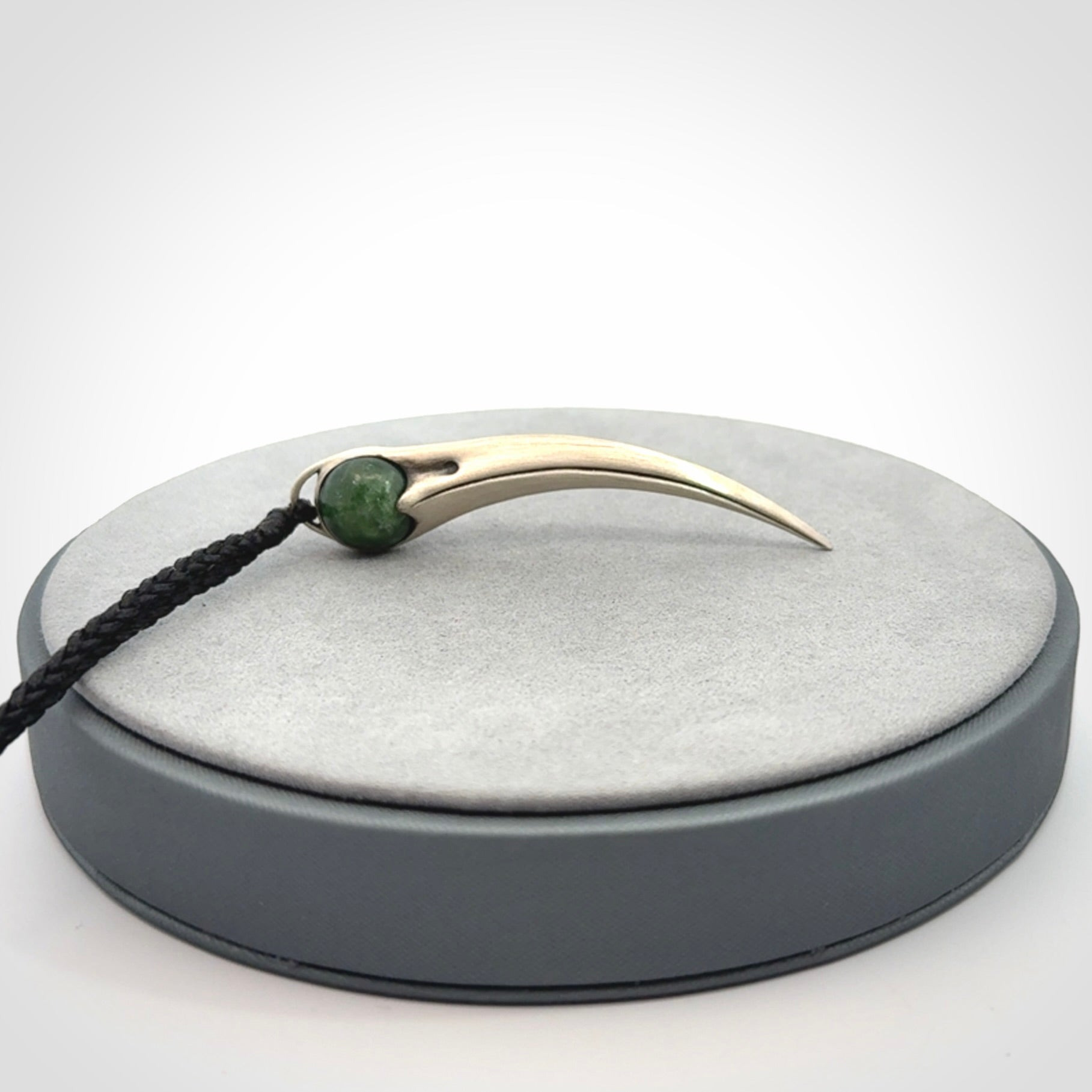 Hand crafted sterling silver with jade huia pendant