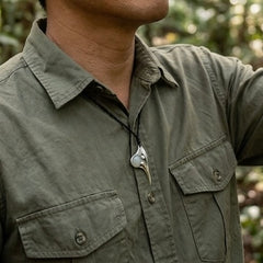 person wearing huia pendant