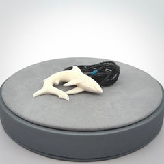 This photo shows a bone shark pendant hand carved in bone. It is provided with an adjustable cord.