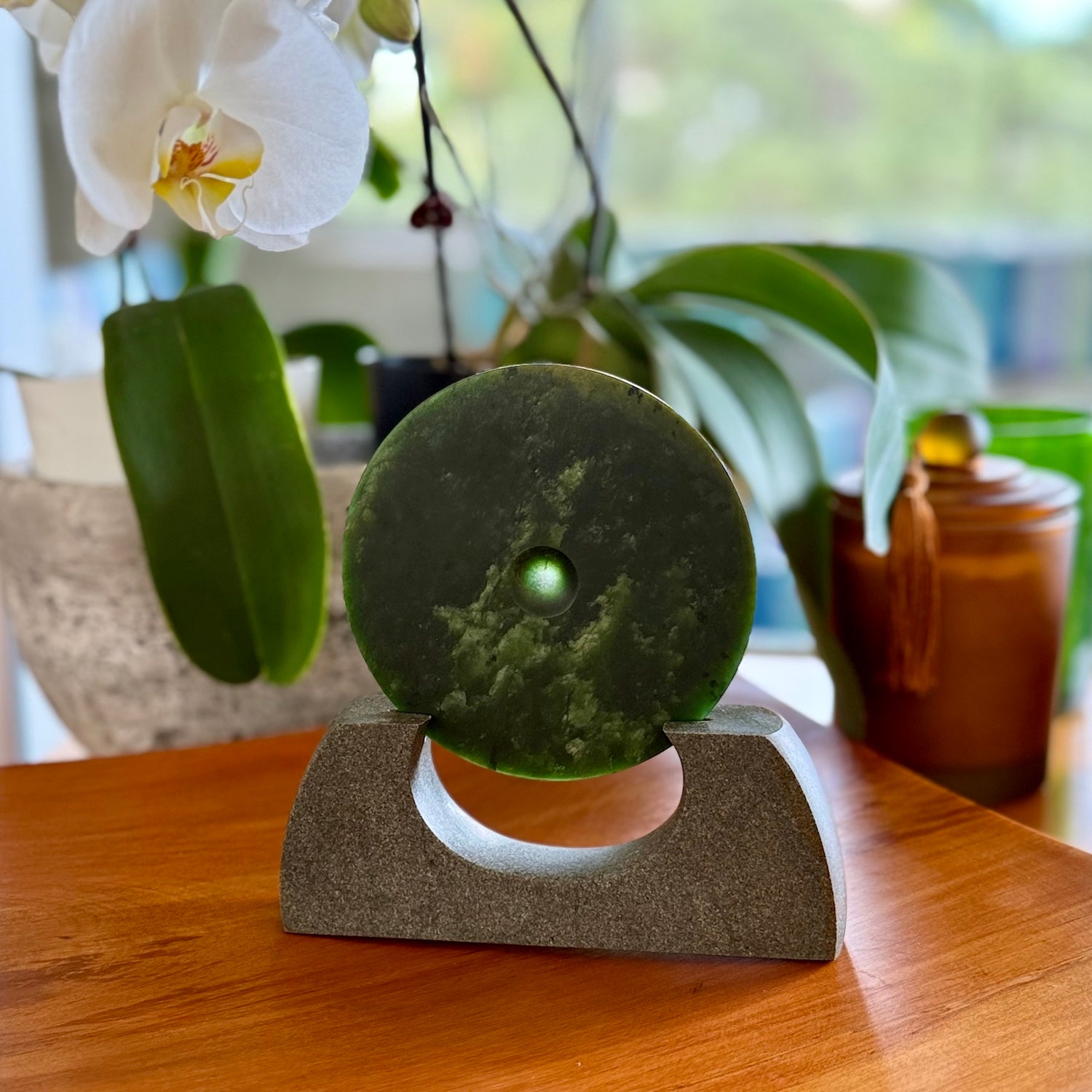 Hand carved New Zealand Marsden Jade Disc with Greywacke stand sculpture. Hand carved here in New Zealand by Ric Moor. This is a 'one only' sculpture, a beautiful display piece.