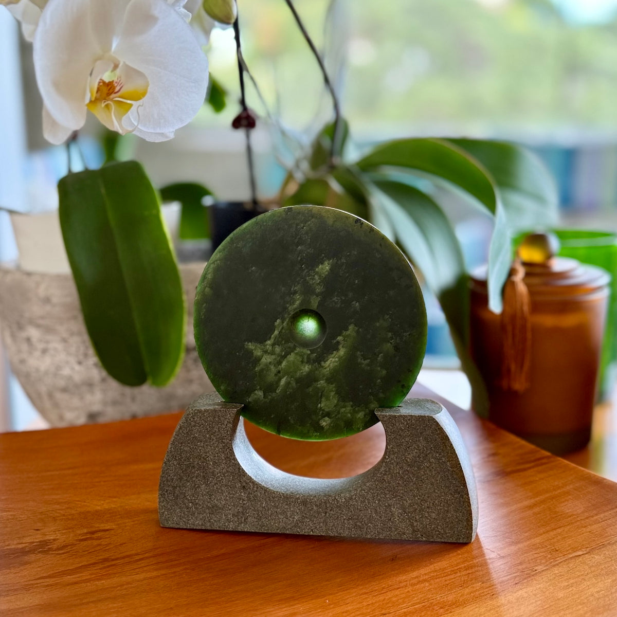 Hand carved New Zealand Marsden Jade Disc with Greywacke stand sculpture. Hand carved here in New Zealand by Ric Moor. This is a 'one only' sculpture, a beautiful display piece.