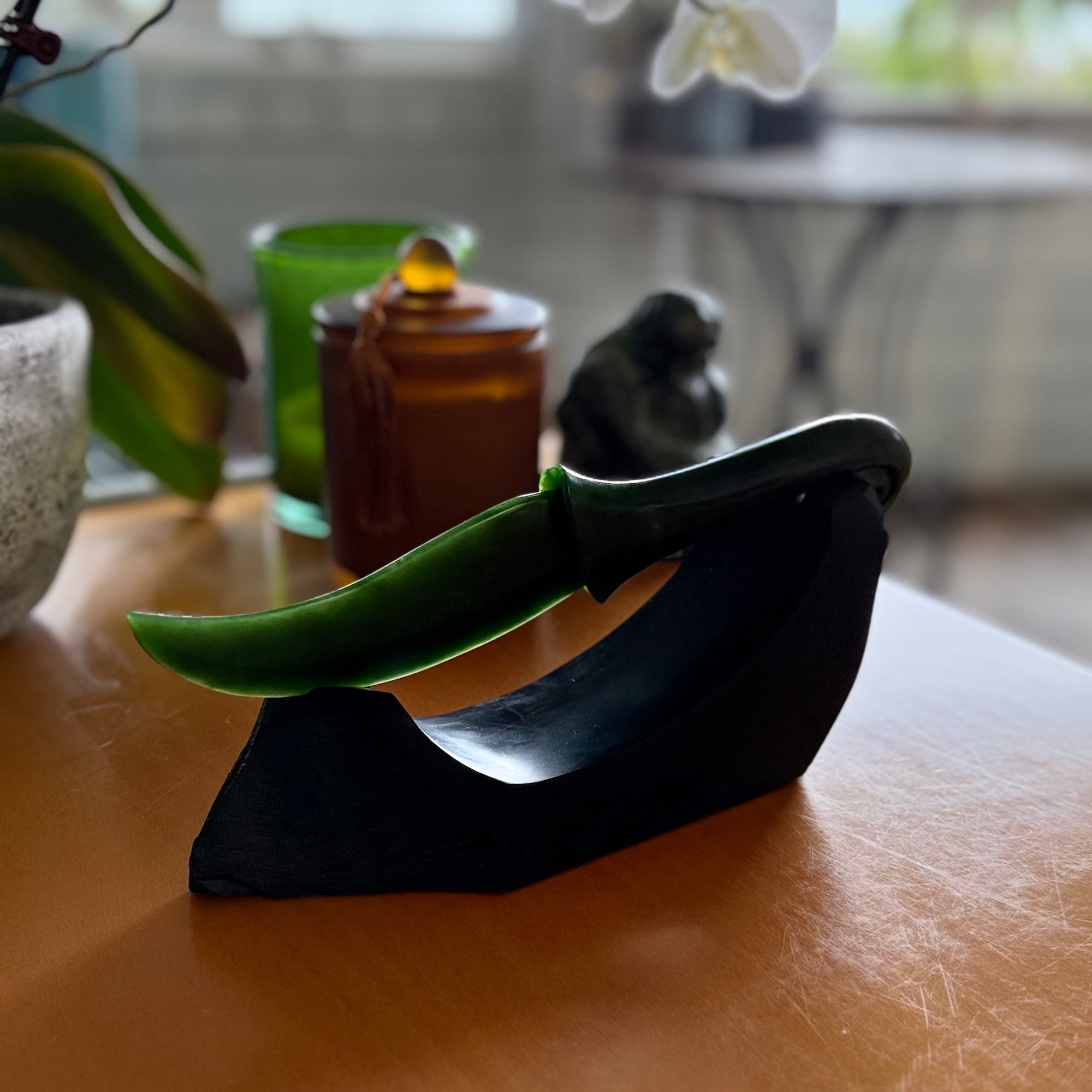 Hand carved large New Zealand Flower Jade knife with koru carving displayed in a Argillite stone stand sculpture. Hand carved here in New Zealand by Ric Moor. This is a 'one only' sculpture, a beautiful display piece.