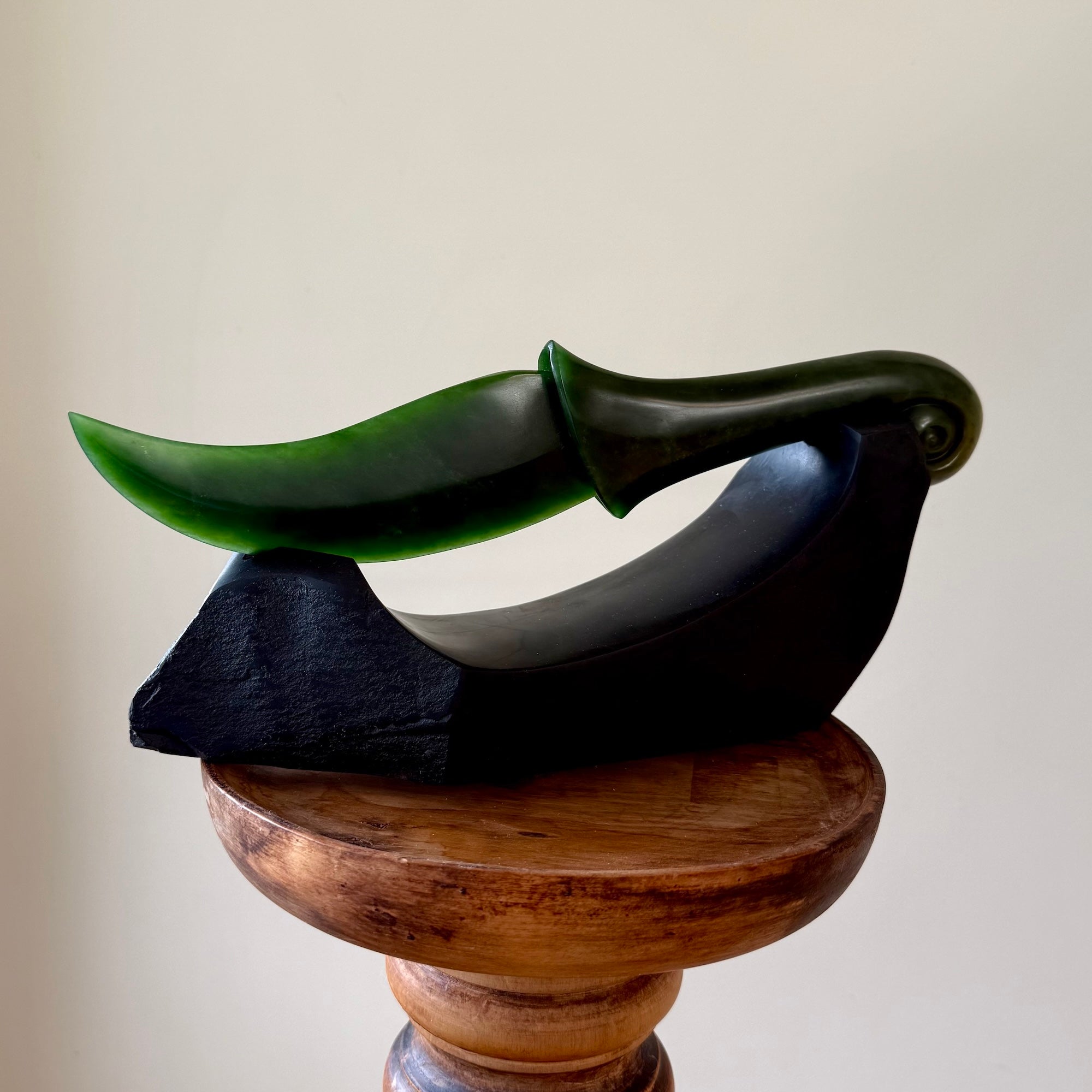 Hand carved large New Zealand Flower Jade knife with koru carving displayed in a Argillite stone stand sculpture. Hand carved here in New Zealand by Ric Moor. This is a 'one only' sculpture, a beautiful display piece.