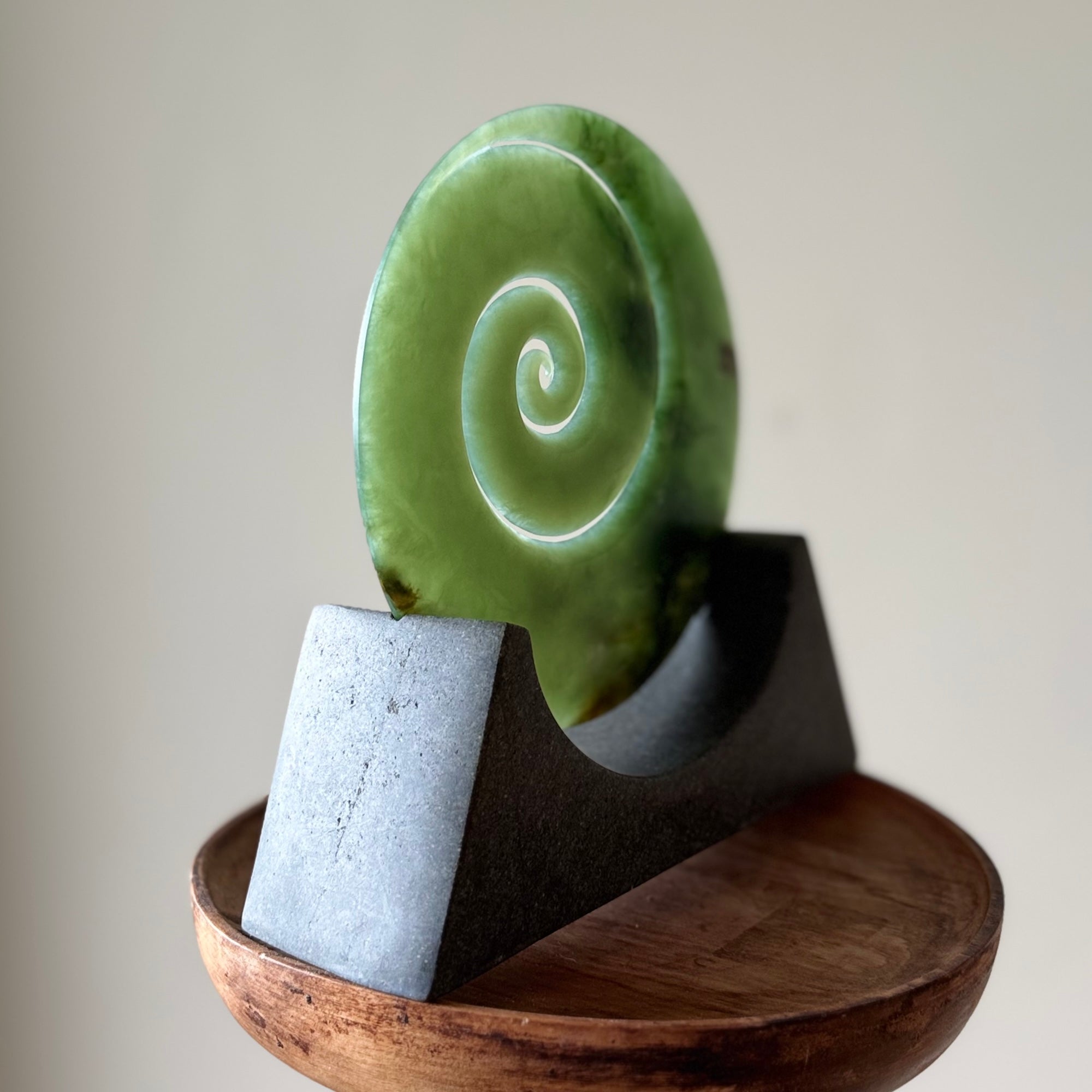 Hand carved large New Zealand Inanga Jade Koru with Greywacke stand sculpture. Hand carved here in New Zealand by Ric Moor. This is a 'one only' sculpture, a beautiful display piece.