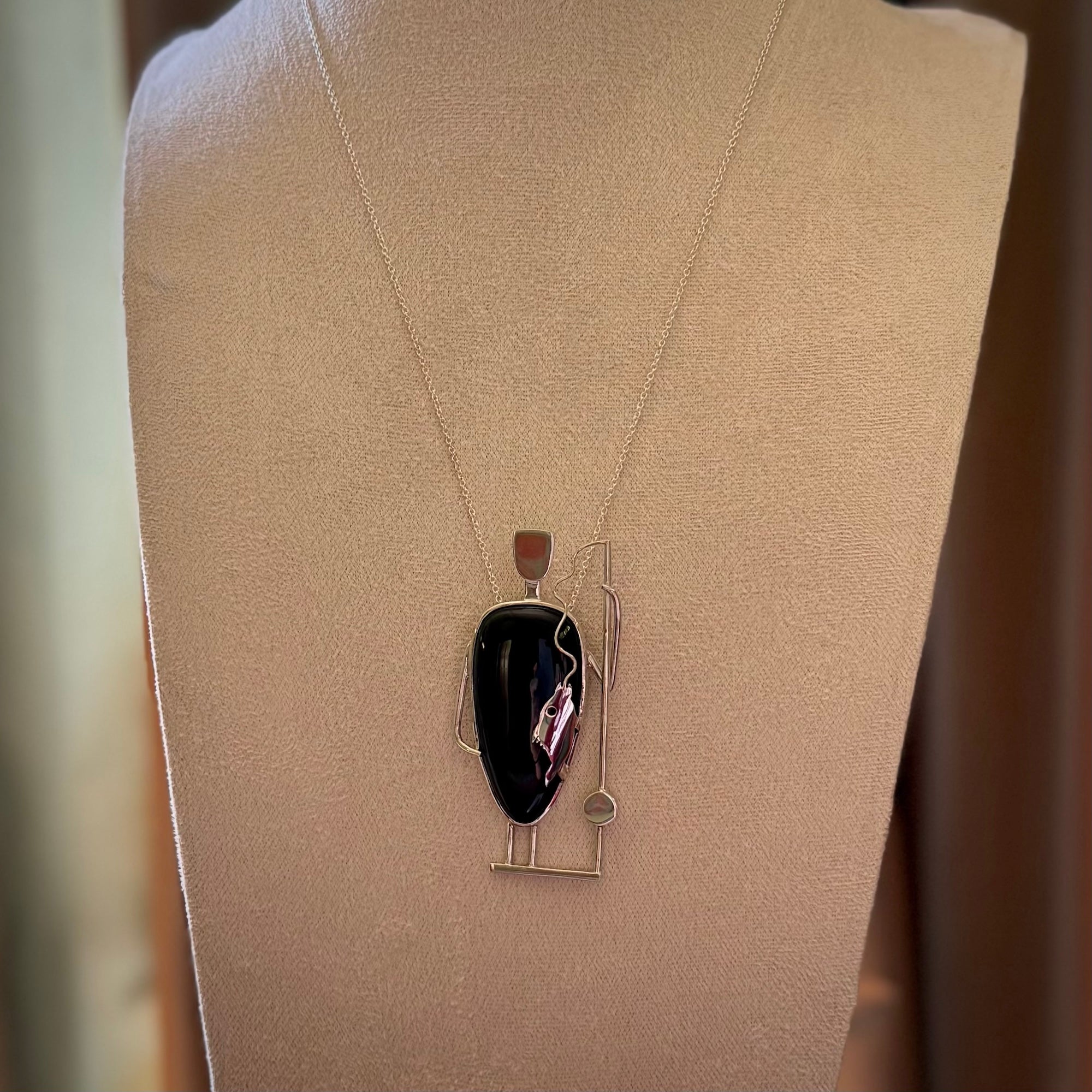 This is a very cool and creative fisherman hand made from Australian Black Jade and Sterling Silver. A fisherman who had caught a fish pendant hand crafted from sterling silver with Black Jade torso. A spectacular piece of art to wear with sterling silver chain.