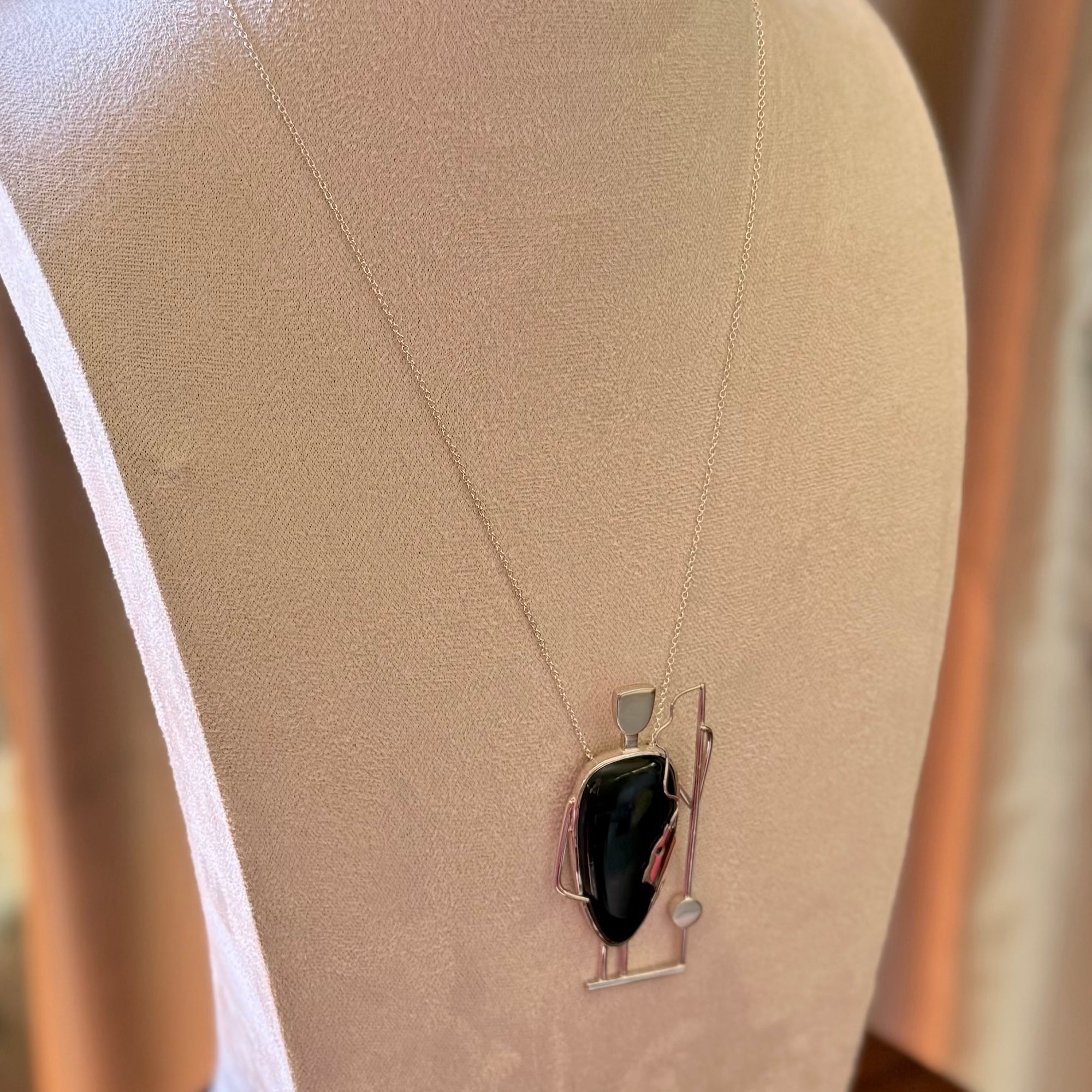 This is a very cool and creative fisherman hand made from Australian Black Jade and Sterling Silver. A fisherman who had caught a fish pendant hand crafted from sterling silver with Black Jade torso. A spectacular piece of art to wear with sterling silver chain.