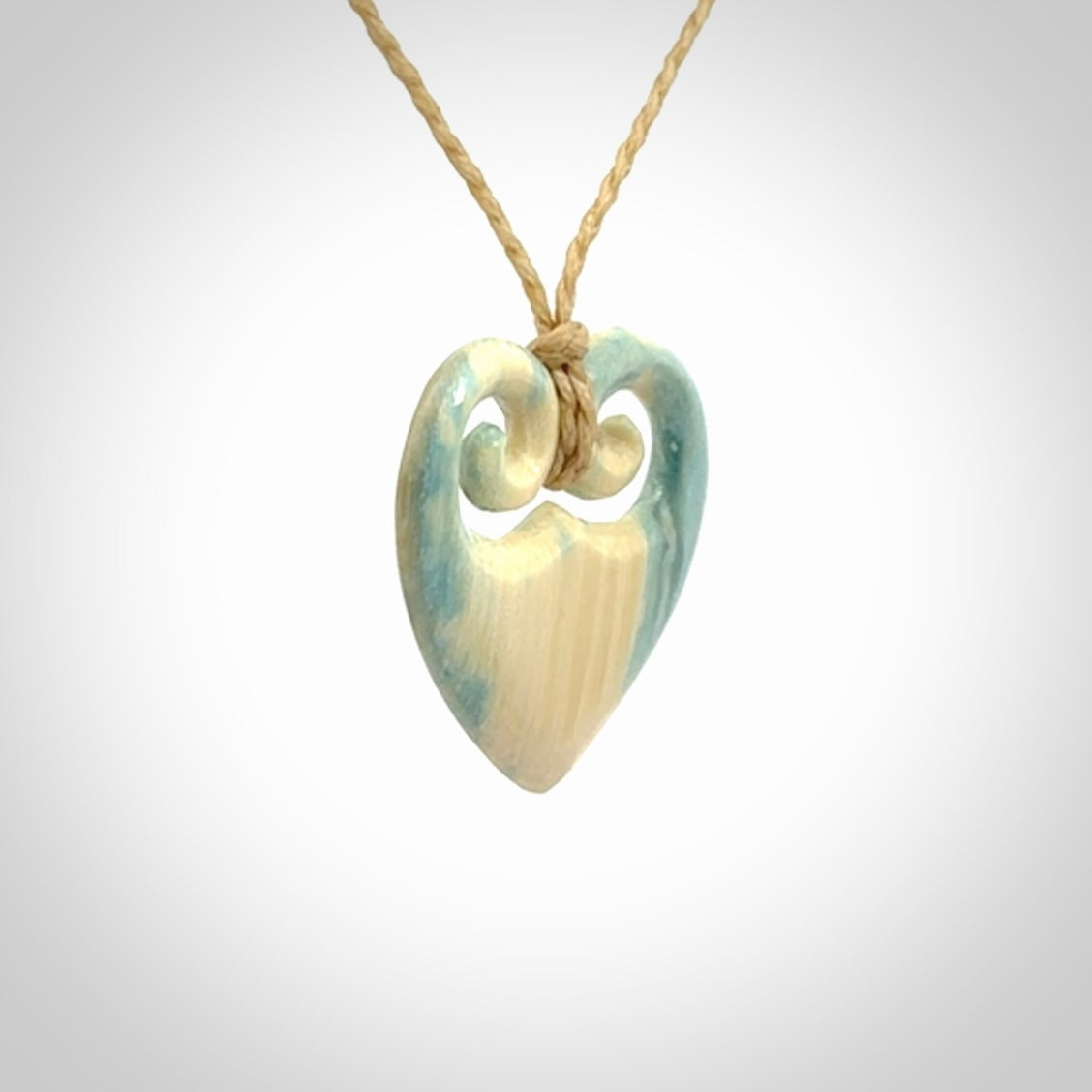 Hand carved heart pendant. Hand made from woolly mammoth tusk. Hand made jewellery for sale online. Rare and unique handmade jewellery. Made by NZ Pacific.