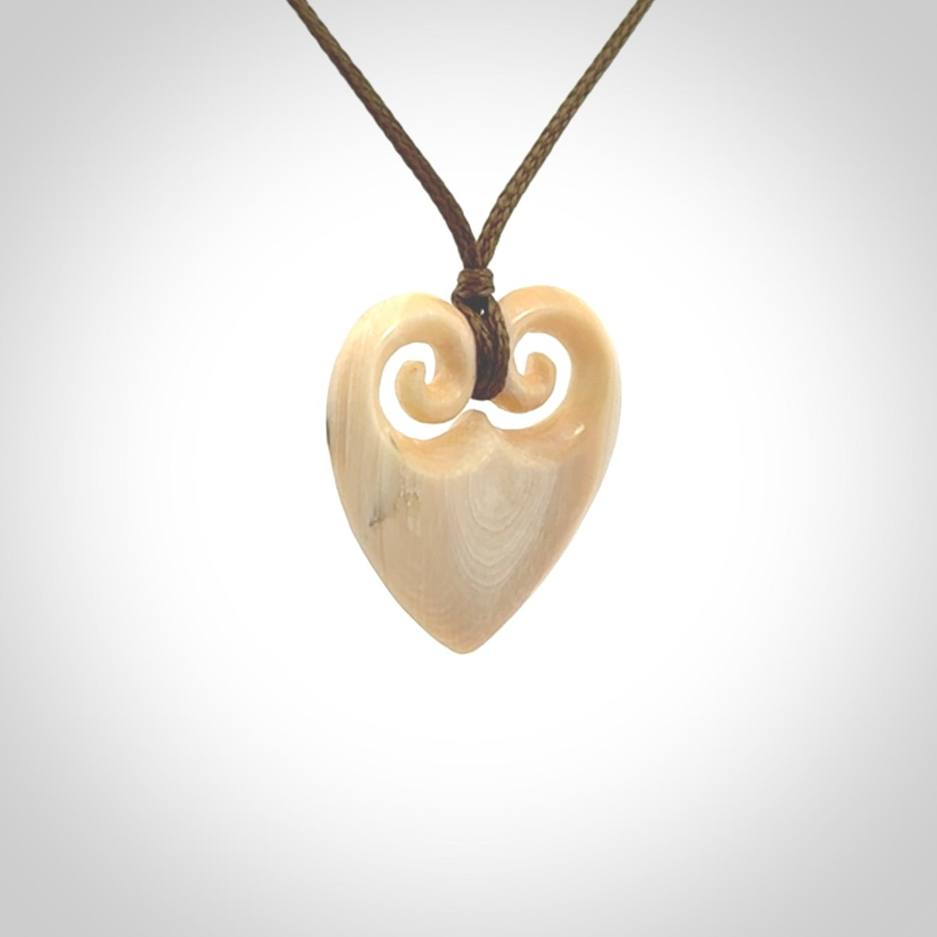 Hand carved heart pendant. Hand made from woolly mammoth tusk. Hand made jewellery for sale online. Rare and unique handmade jewellery. Made by NZ Pacific.