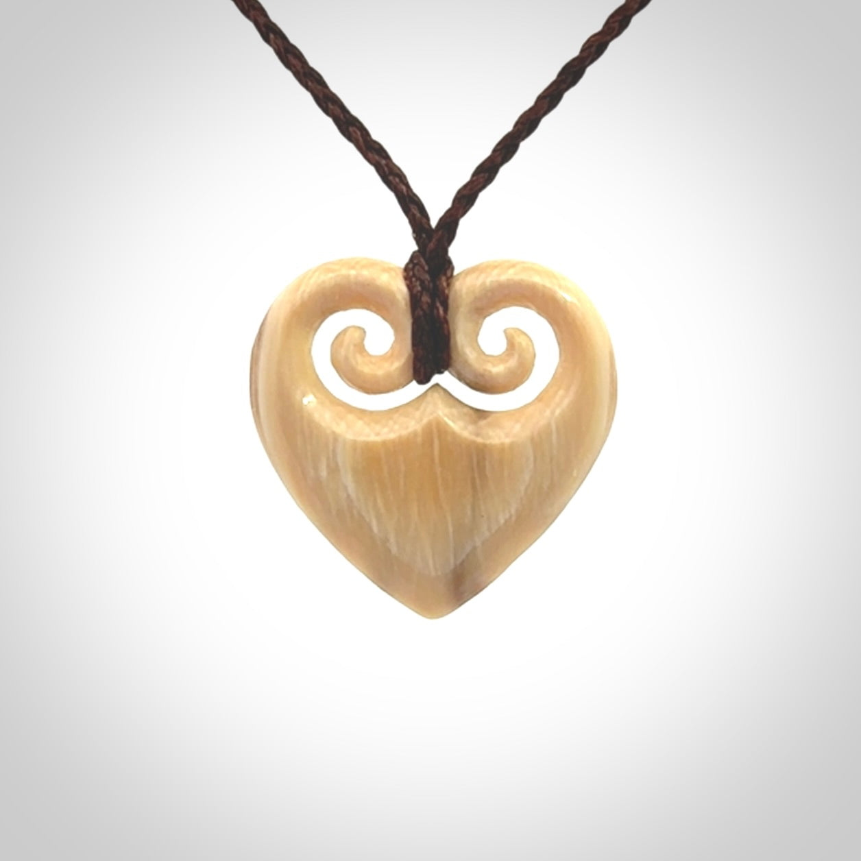 Hand carved heart pendant. Hand made from woolly mammoth tusk. Hand made jewellery for sale online. Rare and unique handmade jewellery. Made by NZ Pacific.