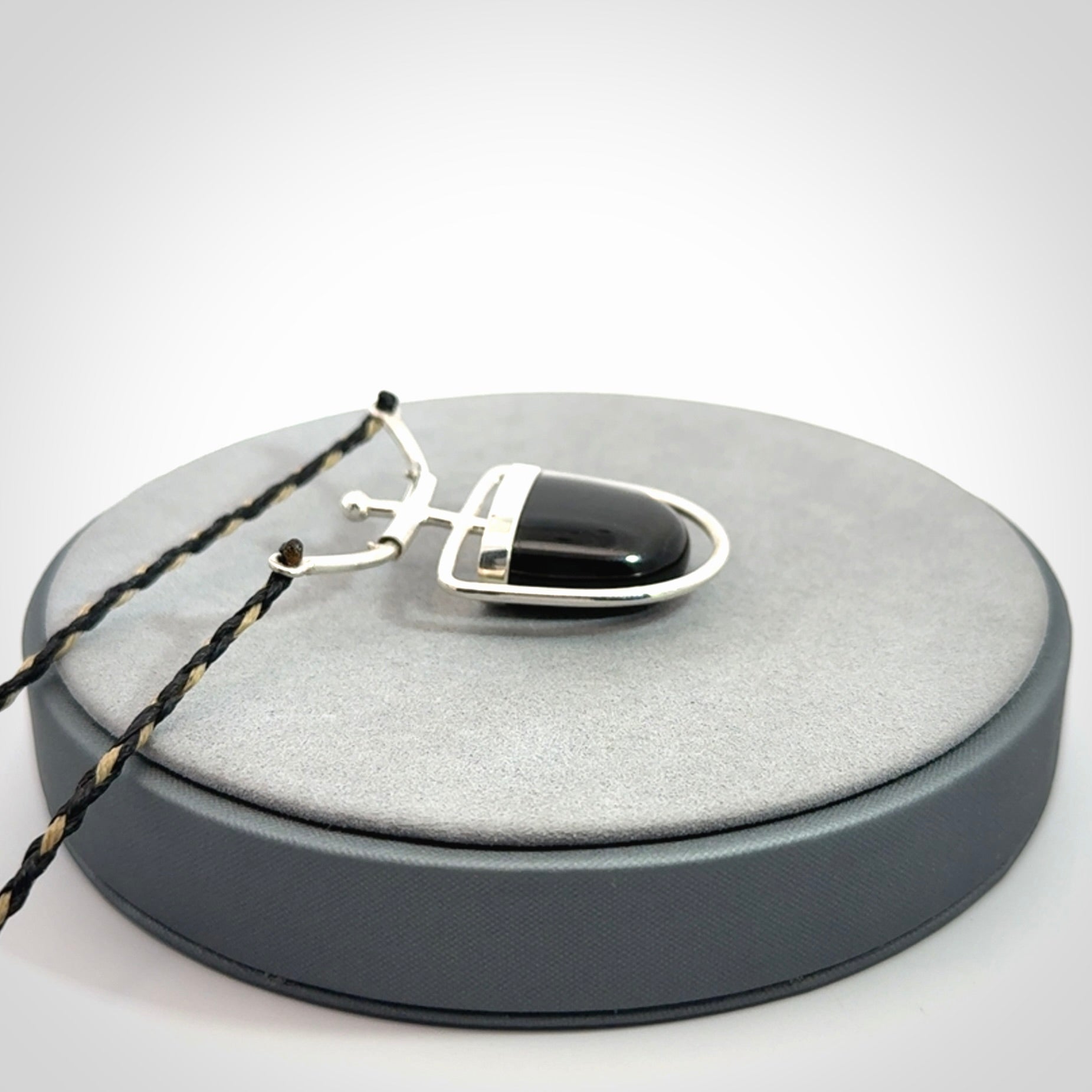 Black jade and silver pendant