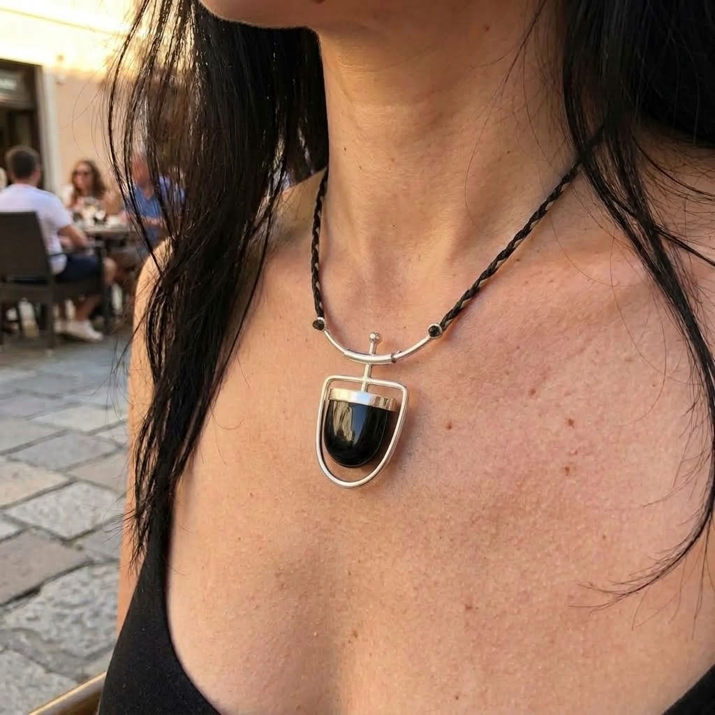 Woman wearing black jade and silver drop pendant