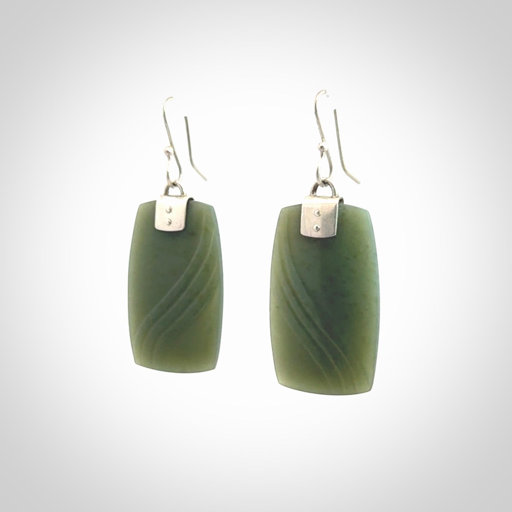 These are stunning large drop jade earrings carved in New Zealand by Josey Coyle. It is carved from a deep green piece of New Zealand Jade and with Sterling Silver hooks and findings.