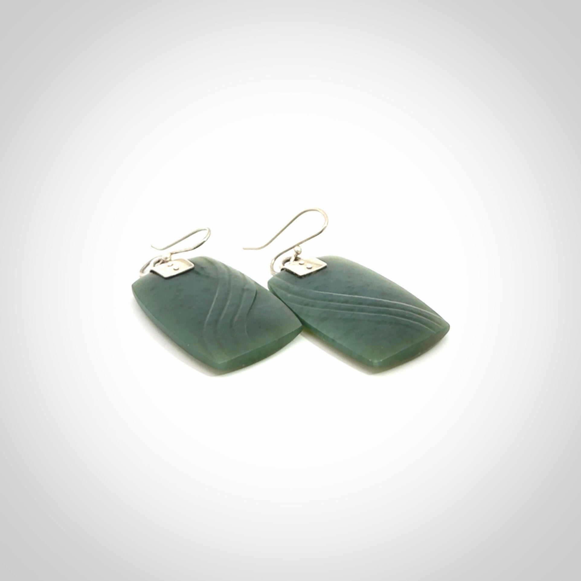 These are stunning large drop jade earrings carved in New Zealand by Josey Coyle. It is carved from a deep green piece of New Zealand Jade and with Sterling Silver hooks and findings.