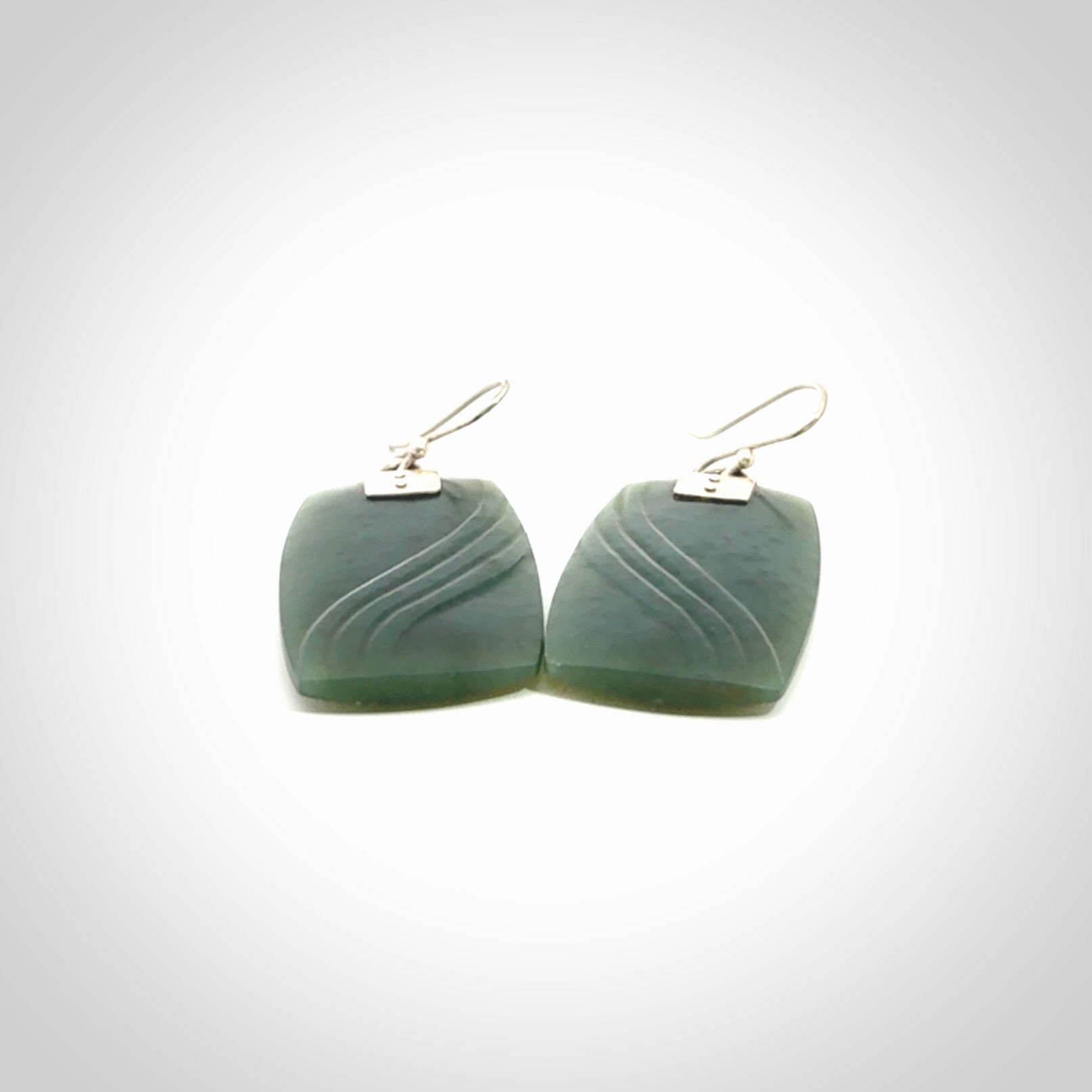 These are stunning large drop jade earrings carved in New Zealand by Josey Coyle. It is carved from a deep green piece of New Zealand Jade and with Sterling Silver hooks and findings.