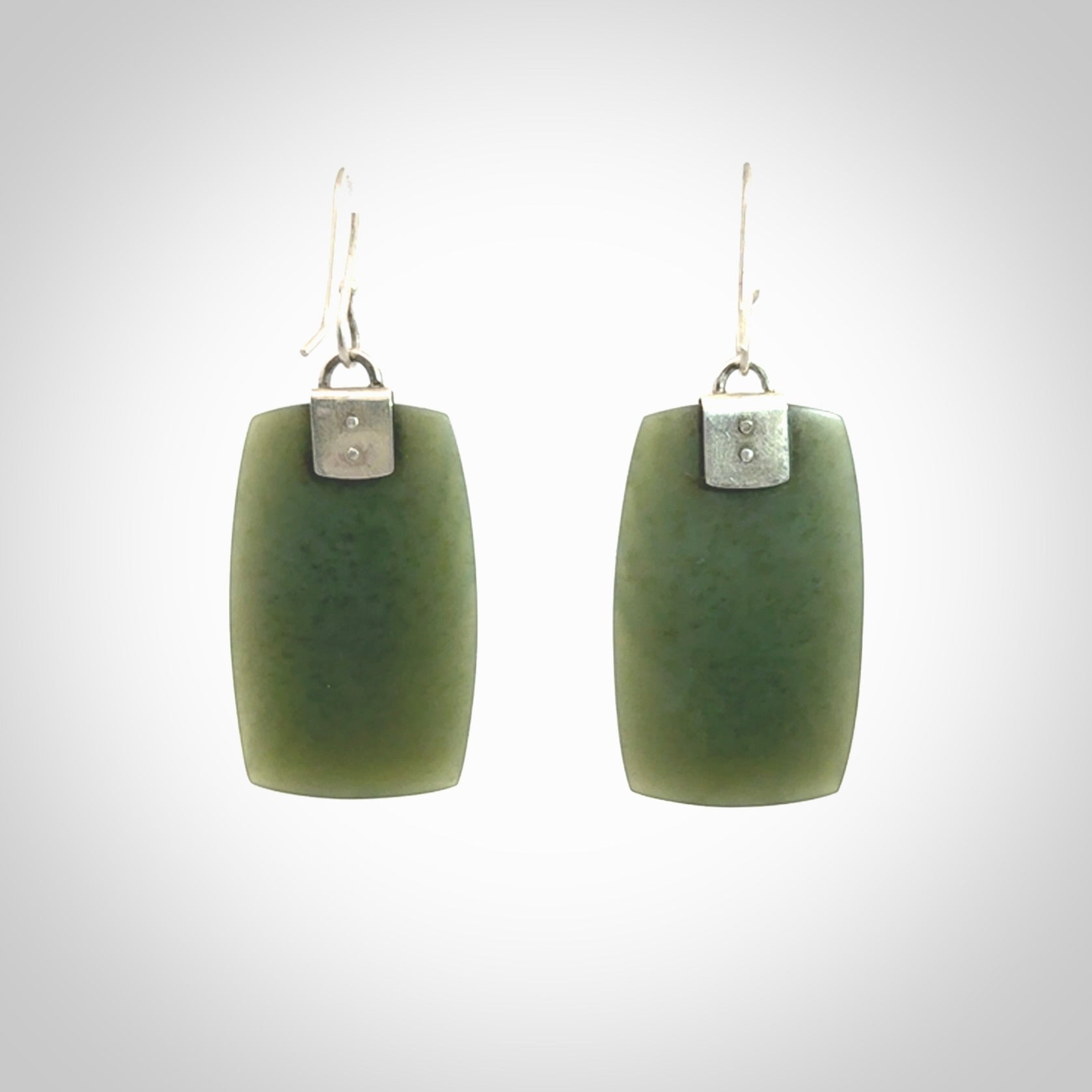 These are stunning large drop jade earrings carved in New Zealand by Josey Coyle. It is carved from a deep green piece of New Zealand Jade and with Sterling Silver hooks and findings.