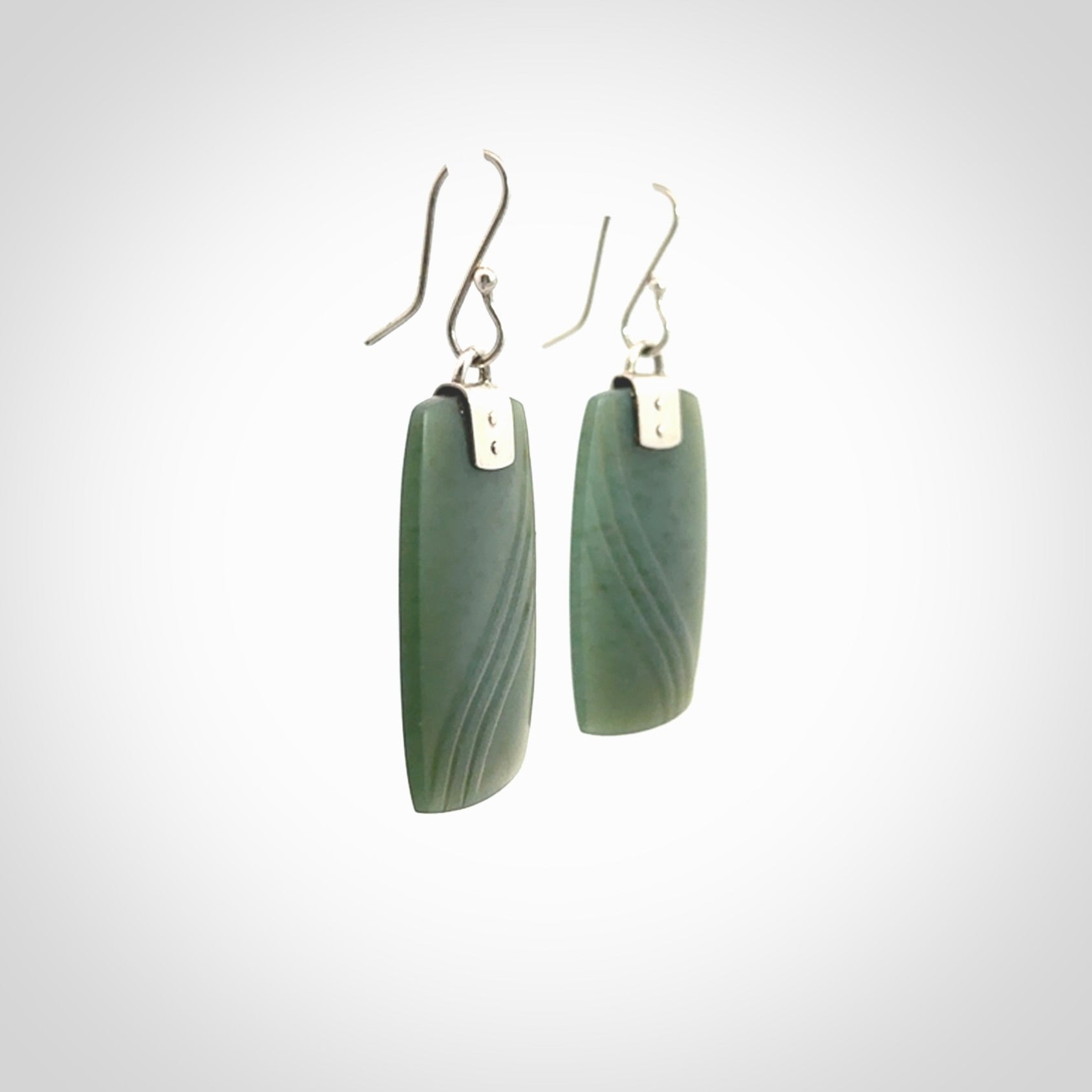 These are stunning large drop jade earrings carved in New Zealand by Josey Coyle. It is carved from a deep green piece of New Zealand Jade and with Sterling Silver hooks and findings.