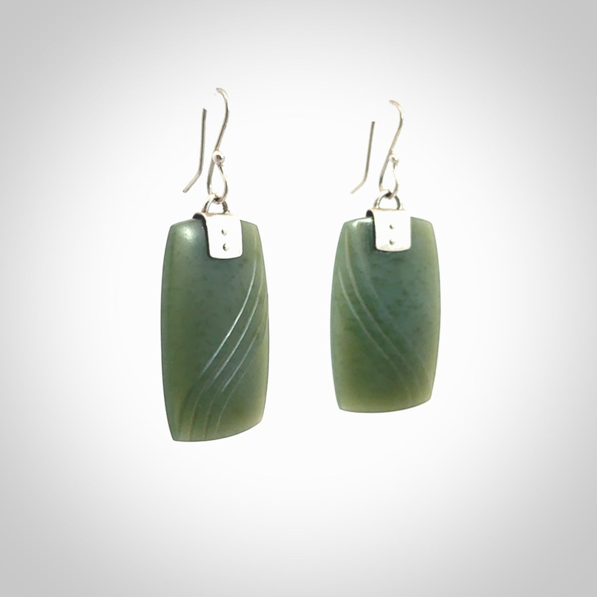 These are stunning large drop jade earrings carved in New Zealand by Josey Coyle. It is carved from a deep green piece of New Zealand Jade and with Sterling Silver hooks and findings.