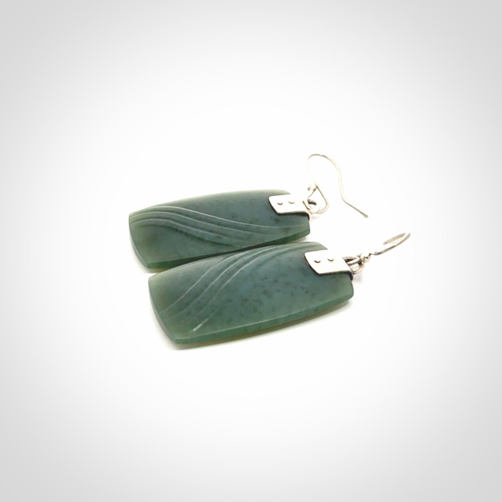 These are stunning large drop jade earrings carved in New Zealand by Josey Coyle. It is carved from a deep green piece of New Zealand Jade and with Sterling Silver hooks and findings.