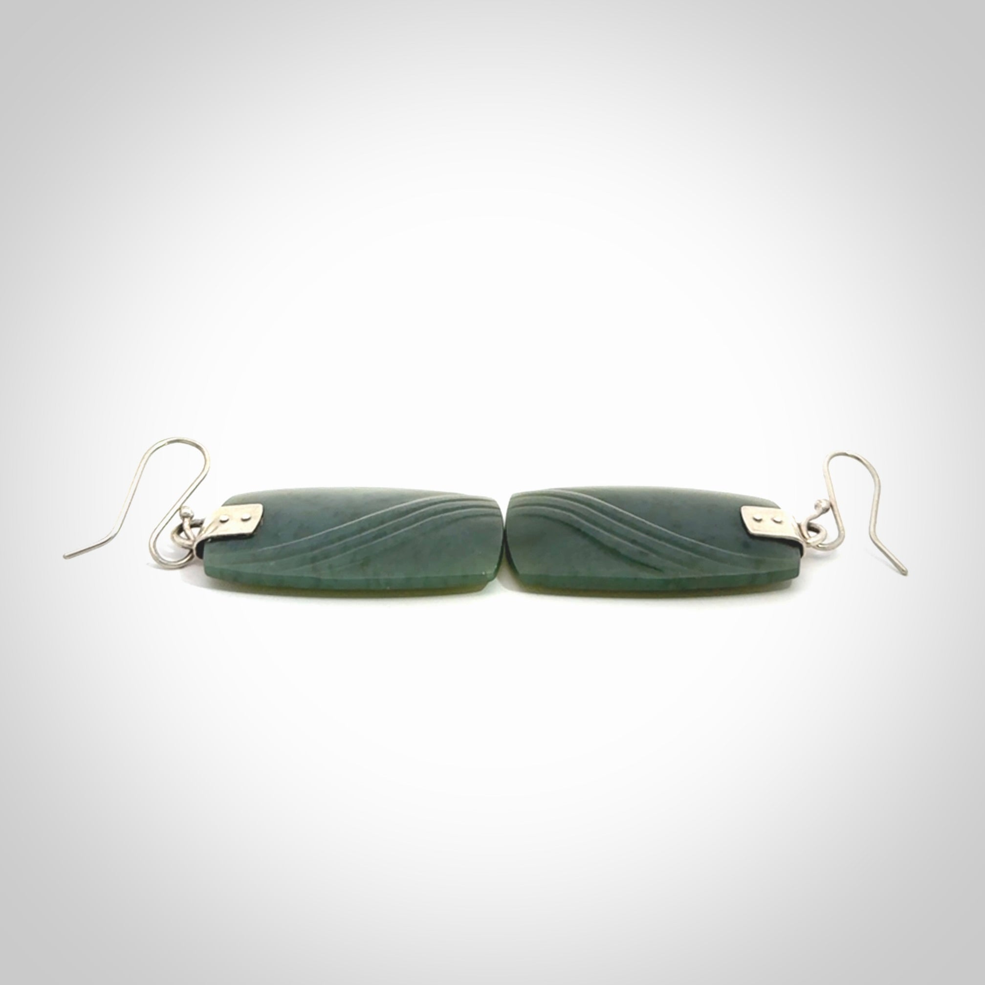 These are stunning large drop jade earrings carved in New Zealand by Josey Coyle. It is carved from a deep green piece of New Zealand Jade and with Sterling Silver hooks and findings.