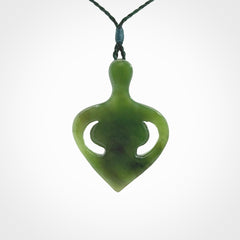 Hand carved Jade heart with mother embracing baby pendant. Contemporary design is jade. Provided with adjustable cord.
