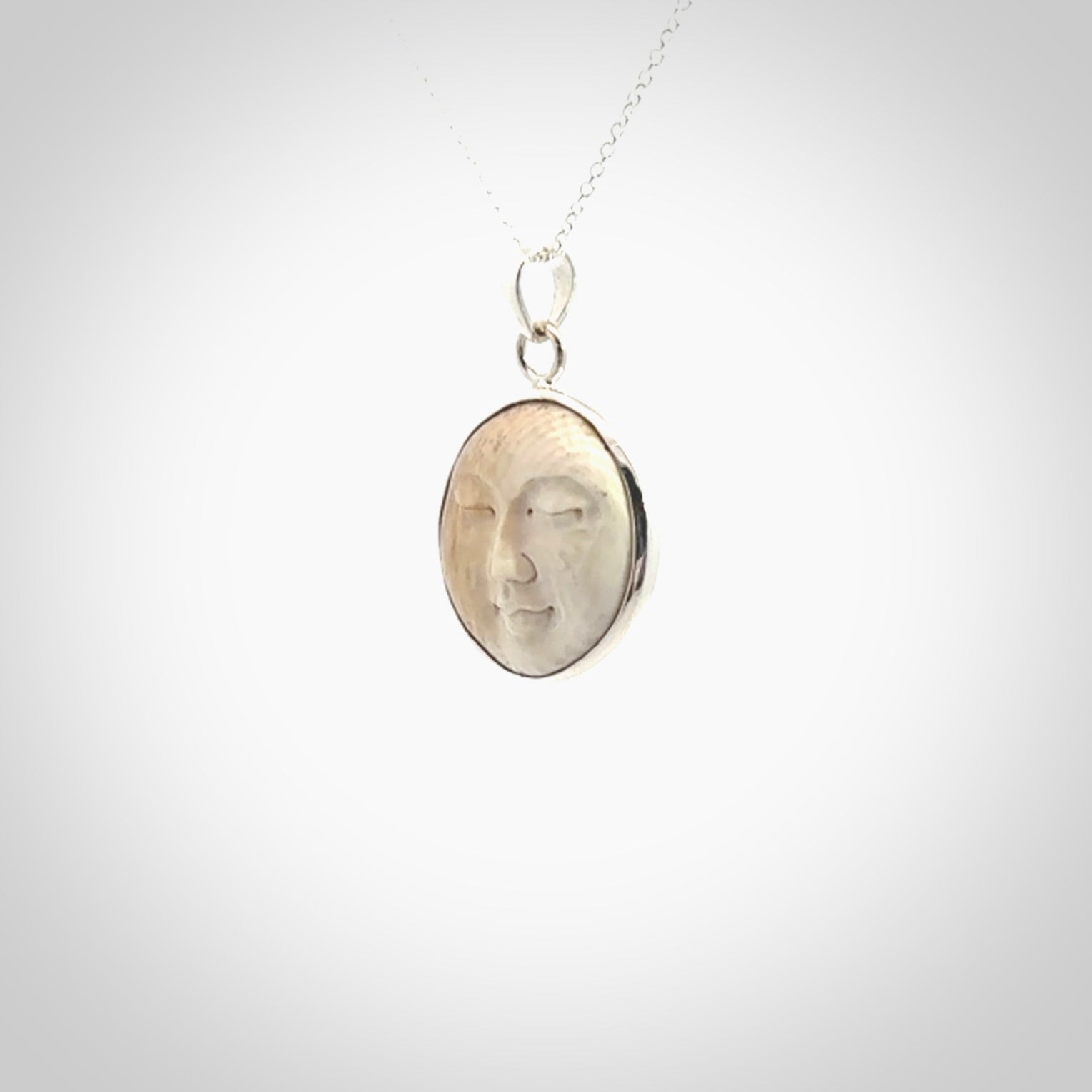 Hand made woolly mammoth tusk moon face necklace. Made by NZ Pacific and sale online only.