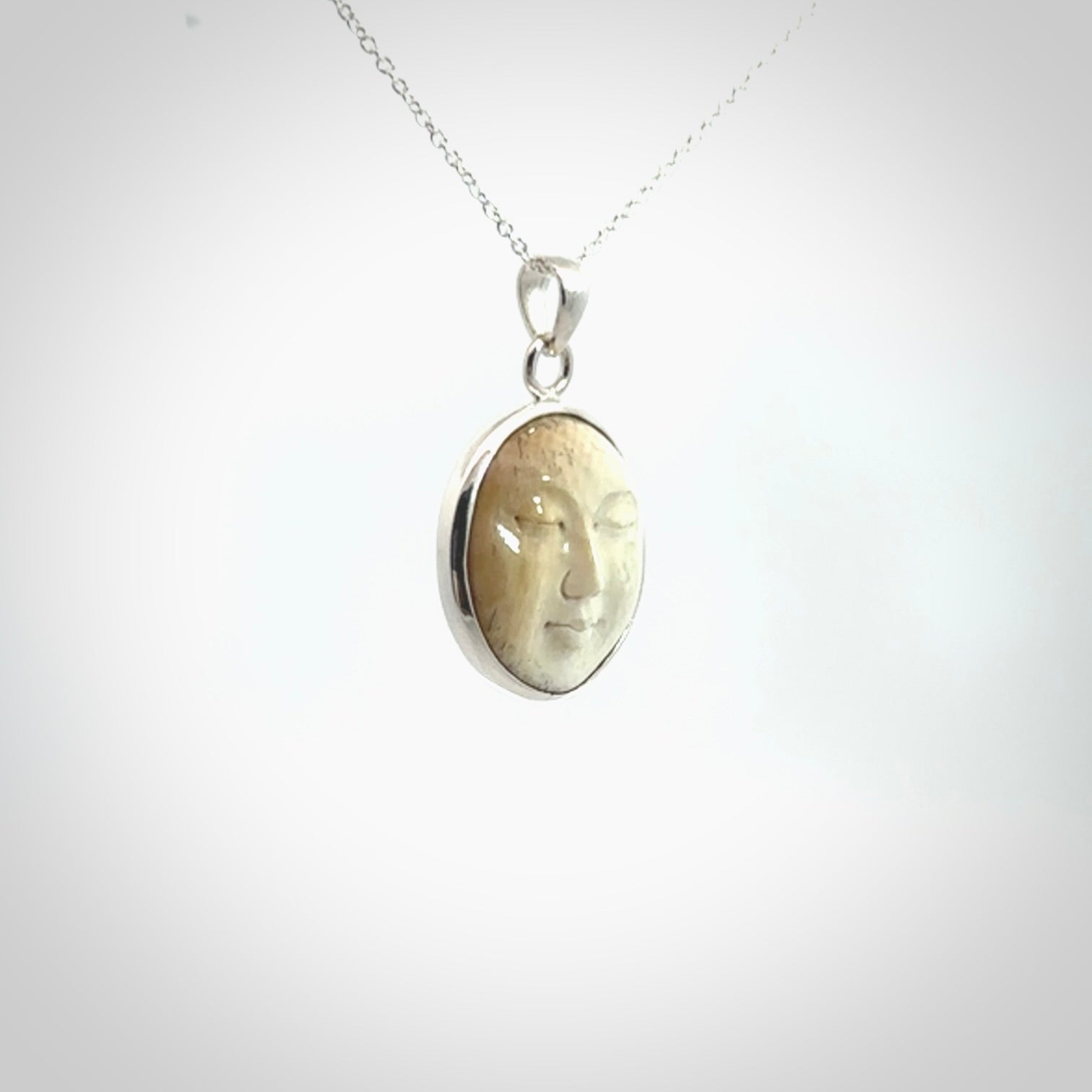 Hand made woolly mammoth tusk moon face necklace. Made by NZ Pacific and sale online only.