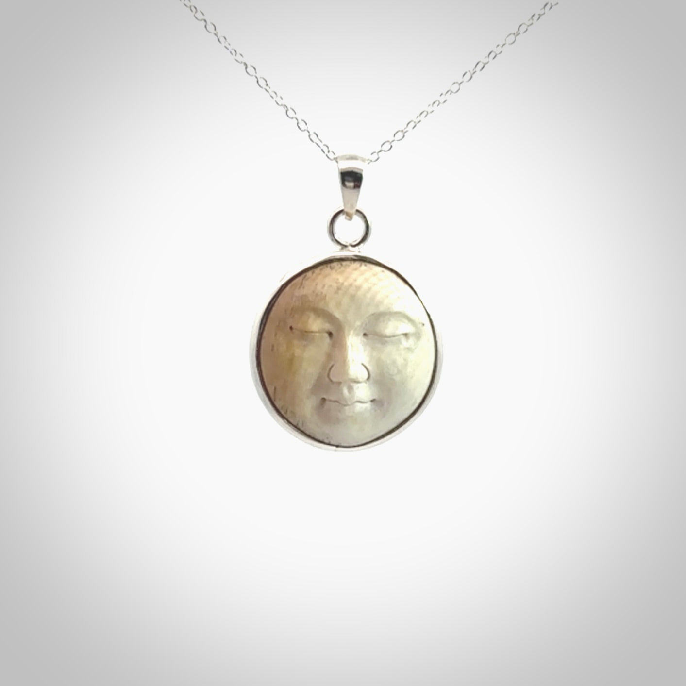 Hand made woolly mammoth tusk moon face necklace. Made by NZ Pacific and sale online only.