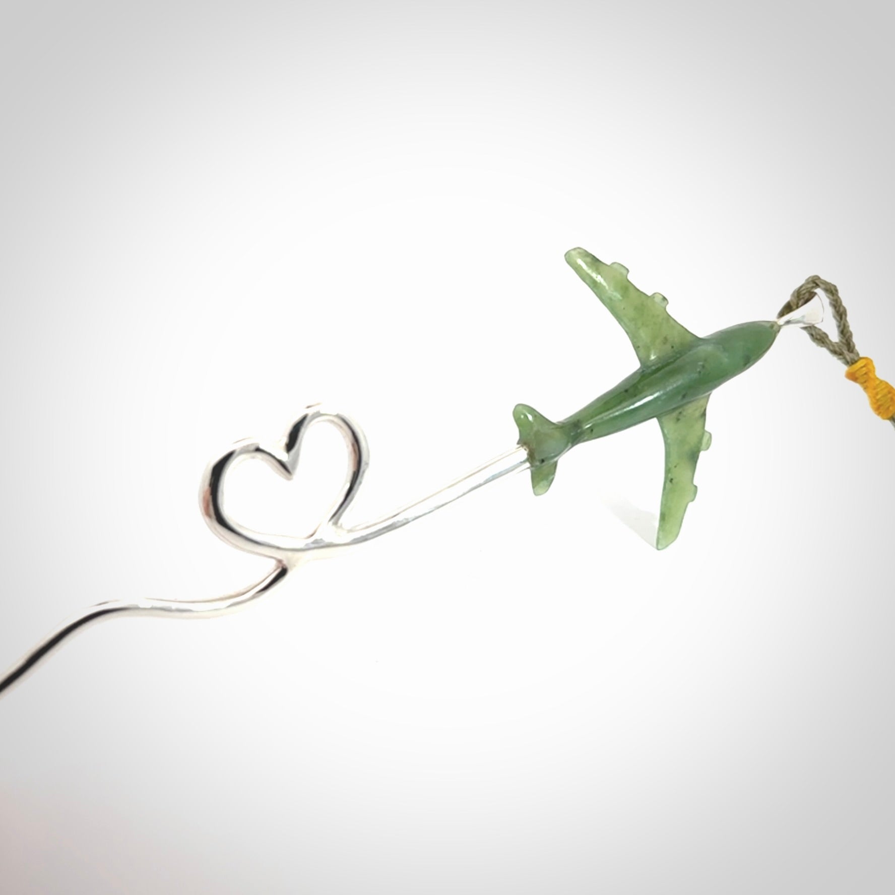 Hand carved plane and heart pendant from Jade with Sterling Silver. This is a very cool piece of jewellery, hand made by NZ Pacific. We provide this with an adjustable cord. Free Postage Worldwide.
